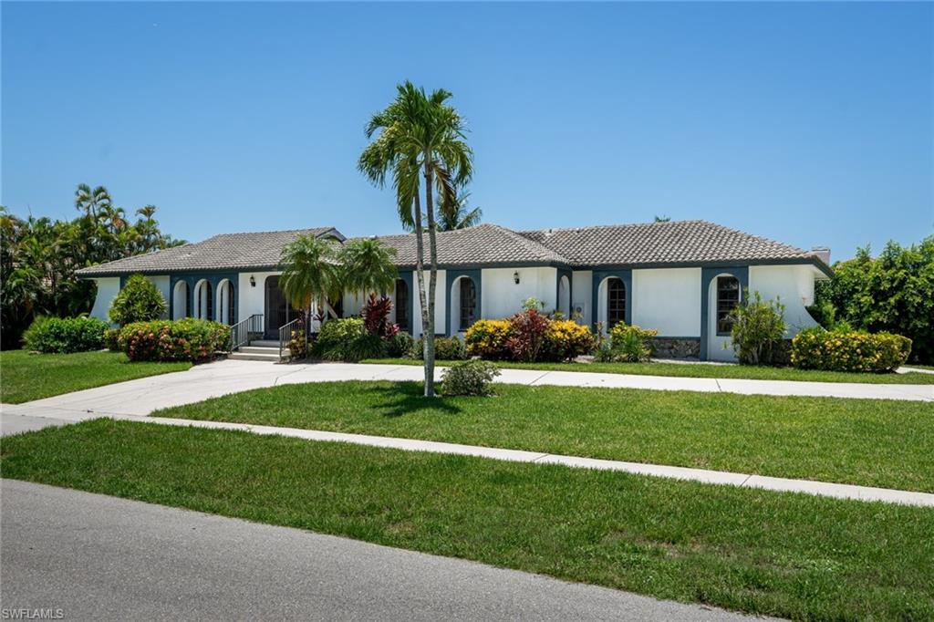 S expo. Wide & long views of converging waterways.   New heavy duty seawall. New dramatic picture window pool screen cage.  Oversize .37 acre well-landscaped lot has circle drive & side load oversize 2-car garage. Excellent expanded Marco Polo design with graceful archways. High vaulted ceilings & pocketing sliders. Panoramic open water views framed by tropical palms. Neutral tile. Tropical color décor accents. Kitchen has lots of cabinets, pantry, wide water view & breakfast bar opening to Family Room & Breakfast Area. Split BR plan has 3 separate wings for 3 BR suites each with their own remodeled full bath.  Master has wide water views & upgraded Bath with walk-in glass shower, new pedestal sink & fixtures, custom cabinets, walk-in closet plus linen.  BR #2 is invitingly tropical, has walk-in closet & upgraded bath with cottage style high vanity, granite top, new fixtures. Charming 3rd BR wing includes remodeled full pool bath with large walk-in frameless glass shower, custom tile, raised panel high vanity, granite counter, new fixtures & walk-in closet.  Spacious pool lanai boasts dramatic picture window screen cage & tropical privacy landscaping as well as a new heat pump.