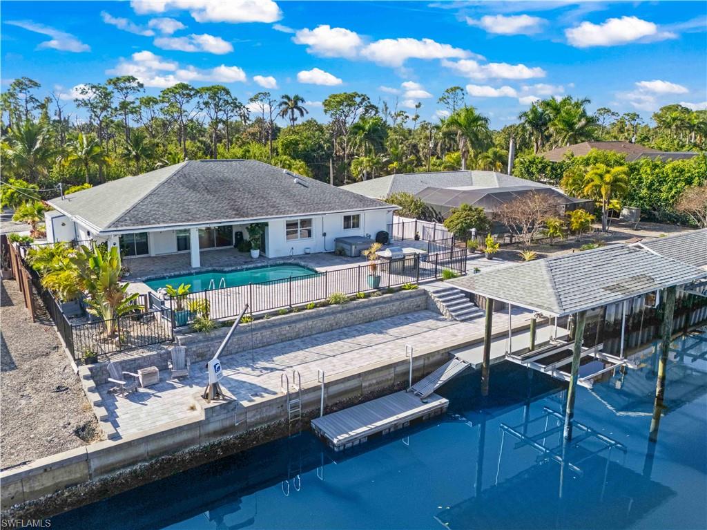 Effortless luxury meets true Gulf access—without a single bridge in sight. Located on the PERFECTLY named Manatee Canal, where dolphins and manatees play, this professionally remodeled 3 bedroom waterfront residence on Pinetree Drive delivers DIRECT, deep-water access to the Gulf, complete with a covered boat lift and private kayak launch - a boaters dream!  Super curb appeal on this oversized lot with extended driveway and additional parking across the street!  Meticulously cared for and it shows both in and out of the home. Inside, the home showcases refined coastal elegance with neutral flooring throughout, a stunning chef’s kitchen featuring shaker-style cabinetry, a large open island, Jennair appliances and quartz countertops - its a beauty! Cornerstone did the remodel and it is spectacular! Filled with abundant natural lighting, luxury upgrades and thoughtfully designed to create a seamless blend of comfort and sophistication, this home flows and is the perfect size with spacious rooms and neutral colors!  The outdoors is a DREAM - an EXTRAORDINARY maintenance-free entertainment oasis awaits—multi patios fully pavered and purpose-built for hosting, with multiple patios, a resort-style pool and stand alone spa, and a fully equipped outdoor kitchen - perfect to hang out with friends and enjoy the amazing paradise that surrounds you. A large fenced side yard, oversized lot, and additional parking across the street add rare convenience. Set in one of St. James City’s most desirable waterfront communities, this exceptional property offers the ultimate Pine Island lifestyle—plus the rare advantage of an ASSUMABLE 2.75% loan.   There are so many additional special features such as a community boat ramp, a 17 mile biking/walking path, boating or walking to multiple restaurants and marinas - you are so close to days of adventures exploring the waters and the incredible islands that surround you.  St. James offers a vibrant lifestyle where you can live your best life!   If you are looking for more than just an ordinary home you have found it!  ASSUMABLE FLOOD INSURANCE OF $1,529 a year!