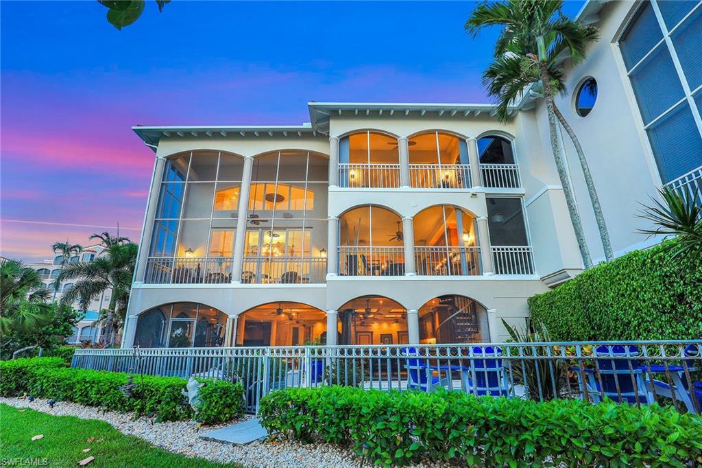 Rarely offered, this oversized end unit Villa sits directly on the Beach and Gulf with 4764 SF under air, total of 7750 SF! Stunningly elegant 3 story custom designed. A Major renovation transformed this Villa with no expense spared!  Like having a house on the beach with walls of glass to bring the outside in! 30 ft ceilings in great room with floor to ceiling stone fireplace. 5 terraces to enjoy beach and Gulf views! 2 outdoor kitchens!  Completely renovated  contemporary,  gourmet kitchen boasts upscale appliances, ice maker, sub-zero refrigerator and drawers, imported Italian Sandaro cabinets, 2 dishwashers, Induction stove, wood and marble flooring, all open to elegant dining room with outdoor terrace and outdoor  kitchen. Absolutely breathtaking master bedroom on 3rd level with terrace overlooking Gulf and Beach. Stunning master bath boasts jet tub,  Burlwood  built in closets and cabinets, separate water closets, and skylights. Each en-suite bedroom has been custom designed with terraces. Jaw dropping, screened in covered lower level lanai will absolutely make entertaining in this home a dream come true! Custom designed huge bar area, coffered ceilings , built in cabinets, built in TV, outdoor kitchen, several seating areas complete with wine room( with 4 subzero refrigerators) and full pool bath. Steps to private pool, beach and Gulf! 3 car garage and 3 story elevator complete . Furnished for your convenience!