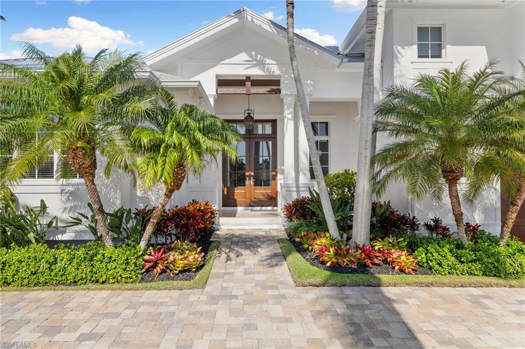 Exceptional Gulf-Access Estate in Royal Harbor | Priced Below Appraised Value ! A rare opportunity to own one of Royal Harbor’s finest waterfront residences—this newly reimagined West Indies-style estate sits on a wide canal with direct Gulf access and no bridges, offering the ultimate coastal lifestyle. Boasting 5 bedrooms and 5 baths all on one level, this luxurious home is a masterclass in timeless design, craftsmanship, and modern convenience. Thoughtfully designed by Falconer Jones Architecture and Seaside Construction, every detail has been elevated—top-tier Wolf appliances, custom cabinetry, reverse osmosis water system, Control4 home automation, and a theater-quality sound system throughout. A double-sided gas fireplace, wine fridge, automated hurricane shutters, epoxy garage flooring, and a full security/surveillance system with remote access underscore the home’s high-end functionality. The expansive open-concept floor plan transitions seamlessly to the outdoors through walls of sliding glass doors, unveiling a lush, private backyard with a showstopping infinity-edge pool and spa. The private dock with 16,000 lb lift and Gem remote is ideal for serious boaters and provides quick, effortless access to the Gulf. The first-floor primary suite is a tranquil waterfront retreat with spa-inspired bath and dual walk-in closets. A separate guest suite with private entry ensures privacy and comfort for visiting friends or extended family. This home suffered no flood or storm damage—a testament to its construction quality and location. Whether you’re seeking a private residence or a lucrative income-producing investment, this property delivers on all fronts. Now offered with a $1,300,000 price reduction—an unmatched value in Royal Harbor.