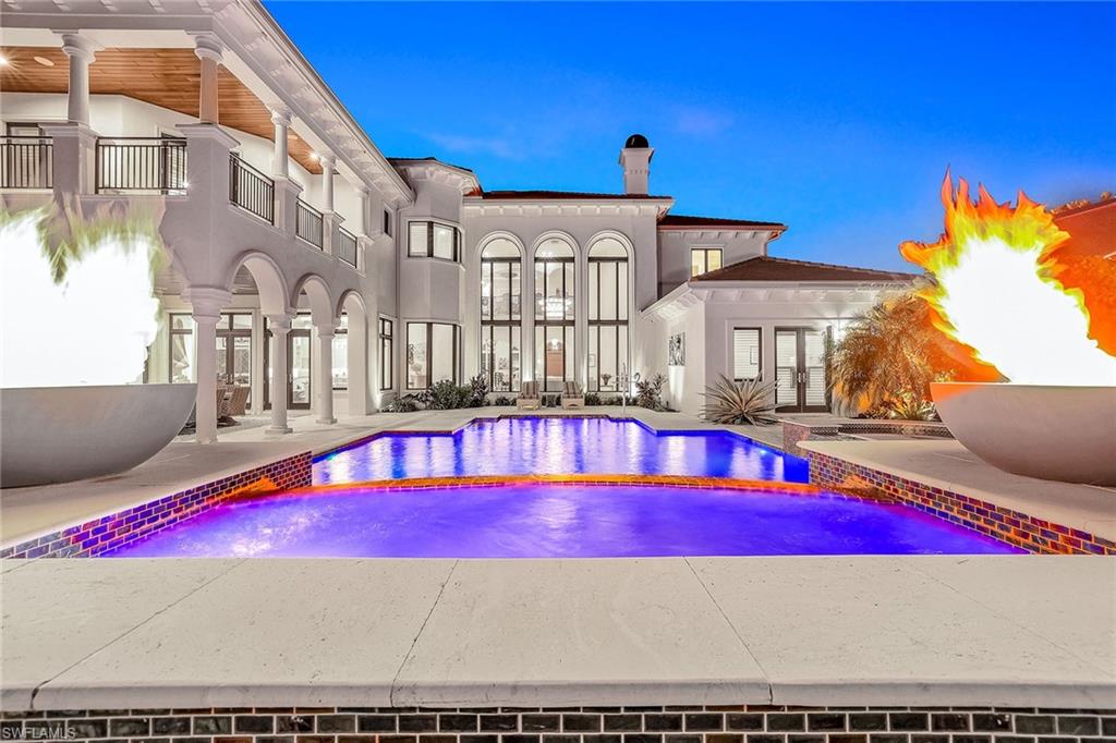 OUTSTANDING VALUE, PRICED WELL UNDER APPRAISED VALUE. Full golf membership immediately available. Under 10 miles from 4 beaches! Welcome to an extraordinary opportunity to live the ultimate luxury lifestyle in Talis Park, where an exclusive full golf membership is immediately available, allowing you to skip the waitlist and begin enjoying world-class amenities from day one. Set on one of the community's most coveted lots, this unparalleled estate is ideally on a secluded 0.5-acre, south-facing cul-de-sac lot. The residence is a masterpiece of design and sophistication, offering an expansive floor plan with two lavish primary suites and four additional bedroom suites, each with a beautifully remodeled ensuite bath. A private casita provides an ideal, independent retreat for guests. Convenience and peace of mind are paramount, with an in-home elevator for easy access to all levels and impact glass windows and doors for ultimate protection. For the car enthusiast, the air-conditioned five-car garage offers abundant space for vehicles and storage. Go outside into your private oasis, where breathtaking views of the pristine 15th hole and a sparkling lake create a serene backdrop. This outdoor sanctuary is an entertainer's dream, complete with a fully equipped outdoor kitchen, a stunning saltwater pool and spa, a cozy gas fire pit and dramatic fire bowls. Inside, the home is appointed with extraordinary features, including electric and gas fireplaces, a bar lounge with a backlit quartz bar, a wine dispenser and a stunning 1,100-bottle temperature-controlled wine room. A recent 2023 roof adds a layer of security and value to this exceptional property. Talis Park offers a refined, active lifestyle with a spectacular 18-hole Pete Dye-designed golf course and an array of amenities including pickleball, tennis, bocce, multiple dining options, a state-of-the-art fitness center, and a luxurious spa. You'll also find scenic trails for recreation and a dog park. This ideal location places you just minutes from pristine beaches, fine dining, upscale shopping and RSW International Airport. This one-of-a-kind estate leaves nothing to be desired, offering a unique and refined living experience. Don't miss your opportunity to own this remarkable residence.