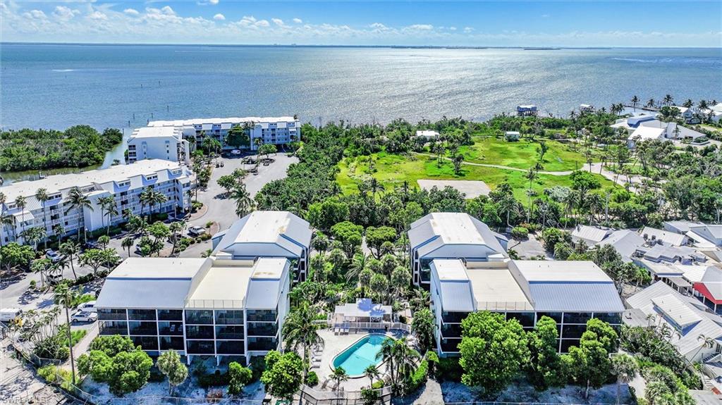 Discover your perfect coastal retreat in this beautifully renovated two-bedroom, two-bathroom condominium nestled at the tip of Captiva Island. This elegantly casual island residence showcases Whirlpool stainless steel appliances, a convenient breakfast bar, a soothing coastal palette and furniture package that creates an inviting atmosphere. The corner location provides an abundance of natural sunlight throughout the living room, dining room, and kitchen, creating bright, welcoming spaces ideal for both relaxation and entertaining. From your windows, enjoy delightful views overlooking the Captiva Resort Villas pool to the south and the newly constructed Captiva Landing pool to the west, offering resort-style living right from your home. Located within the family-friendly South Seas Resort community, this property offers exceptional convenience with the pristine beach just a five-minute stroll away. The vibrant Captiva Village, with its collection of outstanding restaurants, lies within comfortable walking distance, providing endless dining opportunities and island charm. Adventure enthusiasts will appreciate this new water sports location in the heart of Captiva Landing, close proximity to McCarthys Marina, where day cruises and spectacular sunset excursions await. The convenient trolley service provides effortless access to the resort's northern amenities, making exploration seamless and enjoyable. This residence presents an outstanding opportunity for those seeking rental income potential, given its prime location and resort amenities. The warm Florida winters and subtropical climate create year-round appeal for visitors and residents alike. Embrace the fantastic healthy lifestyle with world-class fishing, swimming, boating, and various water sports at your doorstep. Golf enthusiasts can enjoy access through membership opportunities, while the Private Club Membership with Club Captiva opens doors to the exclusive South Seas Resort's amenities and island experiences.