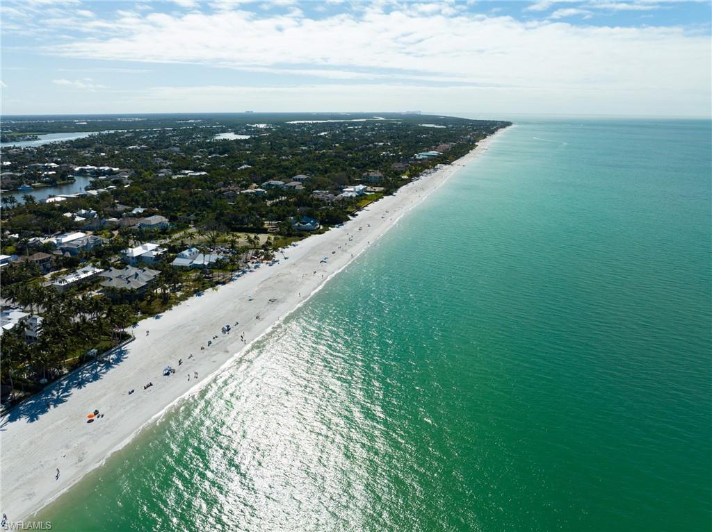 Introducing an exceptional waterfront property in the highly sought-after Aqualane Shores neighborhood. This home offers 4 bedrooms, including an in-law suite, and 3 full baths plus 1 half bath, spread across just under 4,000 sq ft of refined living space. Set on a .32-acre lot, this residence features Southern exposure and captivating, private canal views. The property showcases a boaters dream, and rarely available covered boat house with a boat lift. The lushly landscaped yard surrounds an expansive pool and spa, complemented by seamless indoor-outdoor living with spacious dining, sunning, and entertainment areas. Step inside to discover a blend of sophistication and comfort with natural light pouring in from every angle. Adorned with beamed cathedral ceilings, and a gas fireplace, the interior boasts sleek countertops, stainless steel appliances with gas cooking, and a unique stained glass wine closet. Located just four blocks from Naples renowned beaches and walking distance to the famous dining, shopping, and entertainment of 3rd St S and 5th Ave S, this property offers the dream Florida lifestyle. In a matter of minutes you are taken from your private boat dock to the Gulf of Mexico.
Whether you're seeking a refined primary residence or a luxurious getaway, this home provides an unmatched blend of charm, privacy, and proximity to Naples’ best attractions -experience the allure of waterfront living at its finest.
