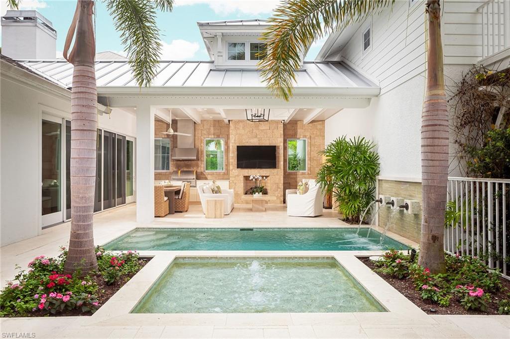 Spectacular Old Naples cottage in a prime location. Originally built in 1951, renovated and expanded in 2017 by Big Island Builders, this exquisite home is truly a masterpiece. Epicurean chef’s kitchen with state-of-the-art appliances, inviting living room with gas fireplace that overlooks the wonderful outdoor living area, perfect for entertaining with outdoor gas fireplace, gas grill, heated pool and spa surrounded by lush tropical foliage. Private guest suite off of breakfast room and master suite on the main level, master suite with walk-in closet, Kallista sinks in bath and rain showerheads. The second level features two bedrooms, two full baths, plus a loft/study. Perfectly situated only four blocks to the beach and just a stone’s throw to the celebrated and renowned upscale shops and dining of 5th Avenue South.