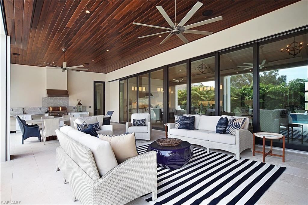 Sprawling on one level, this great room floor plan is where real living meets real luxury. Soaring ceilings are highlighted with inset beams and custom details providing modern, clean lines. Floor-to-ceiling, pocket sliding doors create the perfect entrance to the generous outdoor area featuring a lap pool, large outdoor kitchen and modern fire pit. Slated for completion in the first week of April 2018, this new construction is nestled in the quiet, amenity-rich Pelican Bay community, where residents can enjoy the ideal Naples lifestyle.