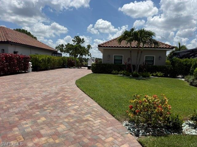 Experience luxury motorcoach living on this beautifully landscaped, east-facing lakefront lot featuring an impressive 840-square-foot coach cabana designed with both elegance and comfort in mind. The well-appointed kitchen boasts Whirlpool stainless steel appliances, high-end granite countertops, an electric range, and a double microwave oven—perfect for entertaining or everyday living.
The spacious interior includes a convenient Murphy bed for overnight guests, while impact-resistant glass and Storm Smart screens provide added safety, security, and peace of mind. Step outside to the inviting lanai, enhanced with stylish lighting that creates the perfect ambiance for relaxing and enjoying tranquil lake views from sunrise to sunset.
Whether you’re seeking a seasonal retreat or a year-round luxury lifestyle, this exceptional property offers premium finishes, beautiful outdoor spaces, and everything you need to enjoy resort-style motorcoach living.

Located within Golden Palms Luxury Motorcoach Resort you will enjoy access to a stunning clubhouse, saltwater pool, hot tub, sauna, and exercise room. There are plenty of activities for everyone and every interest including pickleball, cornhole, fishing, kayaks, paddleboats, and a 1 acre dog park. You will be surrounded by nature, yet only a short drive away from restaurants, shopping, parks, golf, airport, Baseball Spring Training Stadiums, and SWFL Beaches. The Resort is a fabulous place for your Class A, Super C, and even your stacker trailer if painted to match the motorcoach. Let's make this special property your very own piece of paradise.
Professional Photos coming soon.