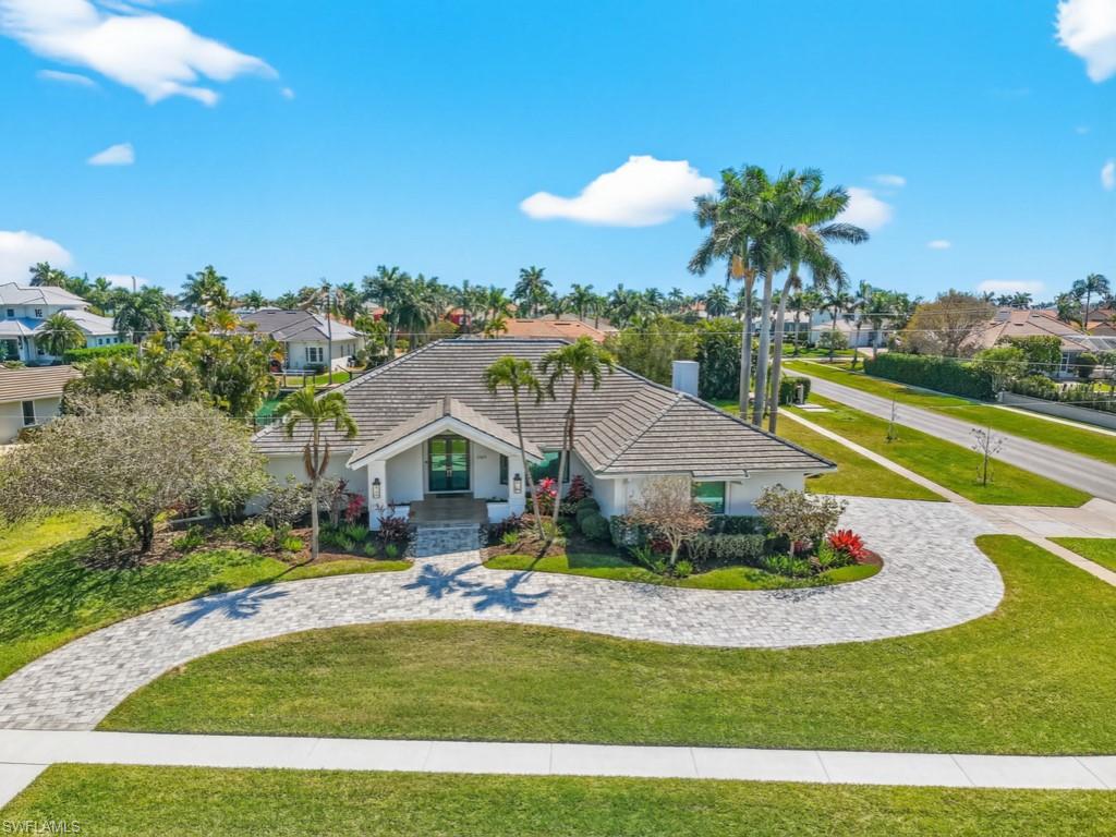 This exquisite residence, fully renovated in 2022, offers direct water access, popular southern exposure for all-day sunshine at the pool & outdoor living areas & a beautiful coastal furniture package. Perfectly positioned on an oversized half-acre corner lot in the prestigious Estates of Marco, the property boasts approximately 160' of seawall & direct Gulf access by boat with no bridges. The home showcases custom white cabinetry, custom closets & shades, all-new tile flooring throughout, new plumbing & lighting fixtures, plus fresh interior & exterior paint.  Designed with a light & airy coastal aesthetic, the open-concept floor plan features a large living area with a vaulted ceiling, double kitchen islands with lots of cabinetry storage space, 4 bedrooms & 3 beautifully updated baths.  Impact glass doors & windows provide peace of mind & abundant natural light.  The expansive south-facing lanai is ideal for entertaining, complete with roll-down screens & a spacious saltwater pool & spa. Relax in the shade or soak up the Florida sun while enjoying tranquil canal & long waterway views.  Boaters will appreciate the new dock & lifts, including 20,000# & 10,000# lifts (dual jet ski platform).  Additional highlights include a new tile roof (2024), new pool equipment (2023), a climate-controlled 3-car garage with a mini-split system, a new paver driveway & walkway leading to the dock. Even though there was never water intrusion, there is a Mayim Flood Control barrier system included.  Move right in and start living the island dream!