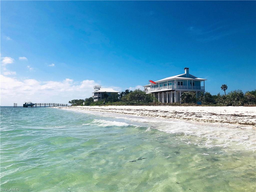 Fantastic one-of-a-kind bayfront estate home bordering the private North  Captiva Airstrip. This home is situated on over 1.25 acres with panoramic views of the water, airstrip & harbor. Built in 2017 to later codes and built to last with the newest low maintenance materials; Hardie board siding, concrete pilings, aluminum railings, and metal roof. Large outdoor spaces with an elevated deck beneath the entire home steps out towards the private beach with a sparkling blue pool. A private deeper water dock along the protected harbor is the perfect spot for your vessel.  Covered porches face east to enjoy views of the bayside beaches & sunrise while you watch for wild dolphins. Four exquisitely appointed bedrooms; luxurious trim, large scale with soaring ceilings, and views of the sand & sea. The kitchen is a focal point for this spacious great room surrounded by a panoramic vista of Pine Island Sound. This home is offered partially furnished and has been a top-performing rental home on the island for several years. Airstrip memberships are also available for purchase to complete your fly-in retreat. Don't miss the chance to own an heirloom property to keep for many generations.