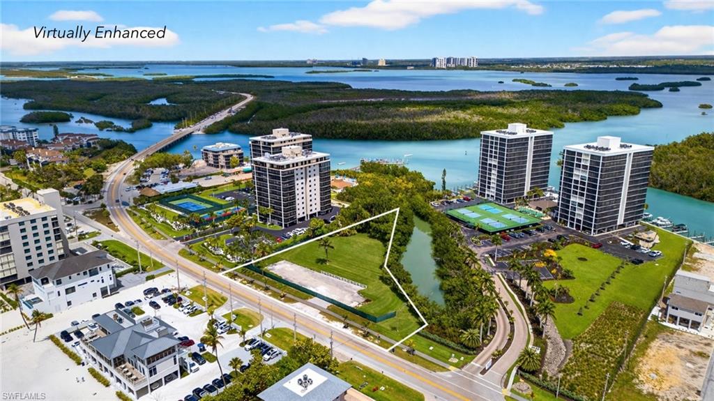One or more photo(s) has been virtually staged, AI generated or rendered.  RARE BAYFRONT DEVELOPMENT OPPORTUNITY ON HICKORY BLVD! Exceptional waterfront parcel spanning over one acre, ideally positioned in the heart of Bonita Beach. This unique property offers the rare combination of direct bay frontage with the Gulf just steps away, creating the potential for beautiful water views of both the bay and Gulf from a future development. Zoned commercial with the flexibility to accommodate either multiple single-family residences or a multifamily development, this property presents a unique opportunity for investors and developers to create a boutique residential or mixed-use concept in one of Southwest Florida’s most desirable coastal corridors. Water hookups are already available, helping streamline the development process. Surrounded by beautiful waterfront homes, beach access points, and the vibrant lifestyle of Bonita Beach, this location places you minutes from boating, dining, and world-class sunsets. With strong demand for coastal properties and limited development opportunities along Hickory Blvd, this parcel presents an outstanding chance to build something truly special in a highly sought-after beach community.