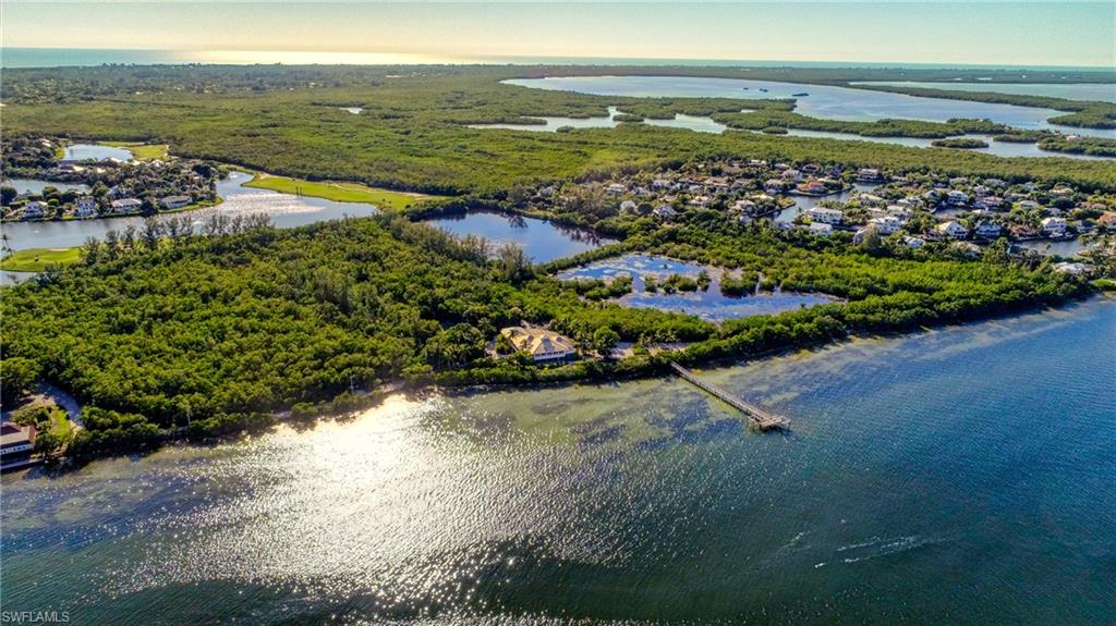 Paradise found on 23+ acres of Sanibel history. Almost an island on an island. 1600 feet (1/4 mile) of Bay frontage once known as Reed’s Landing; home of Sanibel’s first post office, the Sanibel House hotel & the shipping docks. Time has stood still here & privacy abounds. What a place to social distance! Mesmerizing bay views transfix you in this 4 bed, 4 bath Old Florida home flooding it w/natural light, soaring cypress ceilings with windowed cupola, oak floors throughout, huge pool/spa, 2 story pool cage, elevator, tennis court, wrap-around Trex decks, spacious lanai with glass sliders overlooking the bay. Plenty of space to work remotely with an office in the home as well as a custom-designed separate, private guest suite/office. High-speed ethernet wired data cable throughout & WiFi capabilities. Video security. The best part:  A 200’ long Trex dock with 2 boat lifts – a rarity on the Bay that is no longer allowed.  This is grandfathered in.  Furnished with exceptions. A real boater's  - or mermaid's dream.  This is the rarest of the rare on Sanibel to be appreciated by a true lover of the islands & privacy.  Go to www.sanibelbayviewparadise.com for more information.