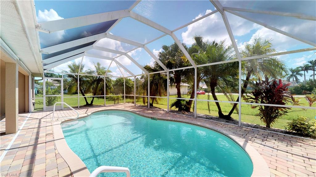Beautiful brick pavers and several shade trees grace this gorgeous pool just off the open concept kitchen, living room and dining area, with plenty of room for entertaining. Lots of natural light makes this home very inviting. Prime location within walking distance to hopping Cape Harbour, minutes from the gulf and several prime waterways. This three bedroom, 2 bath home is move-in ready with many updates: granite counters, stainless appliances, tile backsplash, mosaic tile entry, newer tile bathrooms, large California walk-in closet in the Master, good size laundry room, an extra large 2 car garage, and all impact windows and sliders! ***All Assessments Paid*** Must see this southern exposure pool home before it is too late.