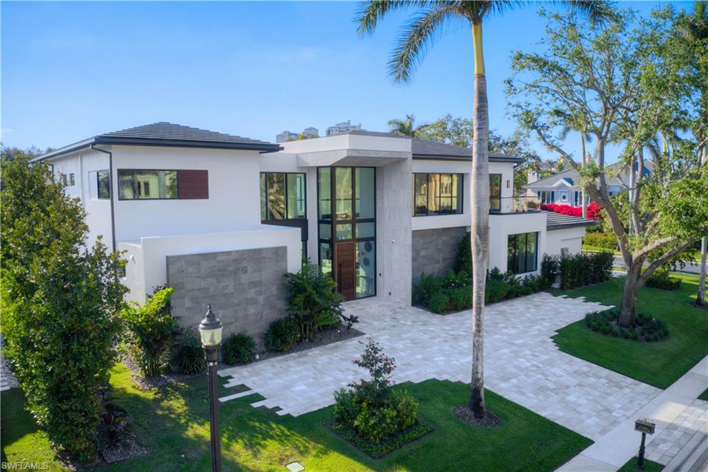 Nestled on a prime corner lot within the secure confines of the gated beachfront community, Bay Colony, this extraordinary residence is a masterpiece of architectural finesse. Conceived by the renowned H-Level Architecture and meticulously crafted by Nian Custom Homes, the home seamlessly integrates contemporary sophistication with the quintessential resort-style living emblematic of Florida. As one of Bay Colony's most expansive residences, this two-story marvel effortlessly harmonizes indoor and outdoor spaces, creating an ambiance that is both refined and recreational—a true embodiment of opulent living.
The interior of this distinguished property boasts five en-suite bedrooms, including an in-law suite with its private entrance, a secluded study, a two-story volume game room/bar, a state-of-the-art chef's kitchen adorned with custom Italian cabinetry and a butler's pantry, a transparent wine room, an elevator for added convenience, a media room, lake-view balconies, and a capacious three-car garage. Outside, the estate unfolds to reveal a resort-style saltwater pool and spa with a swim-up bar and sun deck, a gourmet summer kitchen, and an outdoor living area complete with a bespoke fireplace.
Residents are treated to an array of premier amenities at Bay Colony, including access to the exclusive beach club, private beachfront dining, a tennis club, concierge services, and the option to join the esteemed Bay Colony Golf Club. This residence stands as an embodiment of unparalleled luxury, striking the perfect equilibrium between refined elegance and leisurely extravagance.
Furnishings provided by Robb & Stucky Interiors & Furnishings.