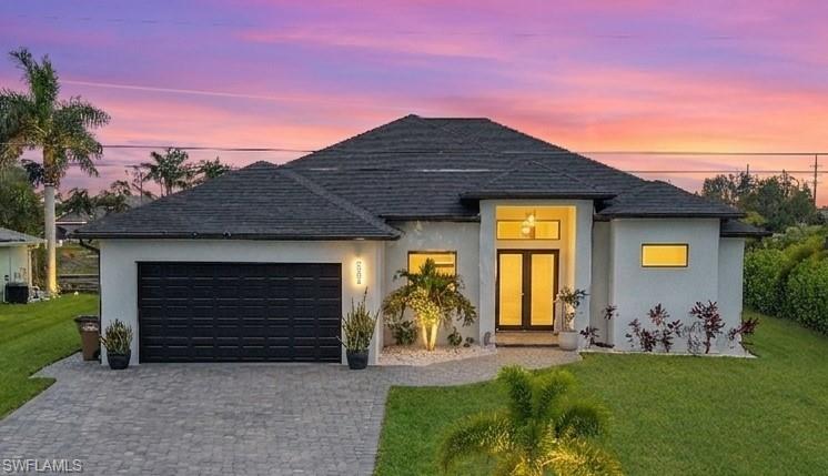 WELCOME TO THIS STUNNING LUXURIOUS WATERFRONT HOME...SPECTACULAR SUNSETS... THIS IS A MUST SEE!!!!

This beautifully designed contemporary residence offers the perfect blend of modern style, comfort, and functionality. Featuring 4 spacious bedrooms and 3 full bathrooms, this home features an open-concept floor plan ideal for both everyday living and entertaining.**ALL ASSESSMENTS PAID!!!!

The chef-inspired kitchen is equipped with sleek black stainless-steel appliances, a large quartz waterfall island, and ample cabinetry for storage. The luxurious primary suite offers a spacious retreat complete with a custom walk-in closet featuring all-wood shelving.**

Step outside to the screened-in lanai overlooking the water and enjoy breathtaking sunset views. The outdoor living area is designed for entertaining, featuring a fully equipped outdoor kitchen with black stainless-steel cabinetry and sink, creating the perfect setting for gatherings with family and friends while enjoying Southwest Florida's year-round outdoor lifestyle.**ROOM FOR POOL...ELECTRICAL PANEL HOOKUP ALREADY INSTALLED!

Additional upgrades include an AQUAKLEEN whole-house WATER PURIFICATION SYSTEM , CUSTOM EVE BLINDS throughout, and a REOLINK security system with six outdoor cameras and a 2TB hard drive for added peace of mind. Best of all, this property DOES NOT REQUIRE FLOOD INSURANCE.**

Additional features include a 2-car garage and an oversized driveway with plenty of parking for family and guests. Conveniently located just minutes from Cape Coral's most popular restaurants, shopping, entertainment, and waterfront attractions, this home offers both luxury and convenience.**

This exceptional waterfront property is ideal for buyers seeking modern elegance, stunning sunset views, and the ultimate Florida lifestyle. **Furniture and televisions are negotiable and available for purchase separately. **Don't miss this incredible opportunity—schedule your private showing today!!!