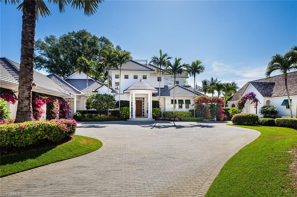 Seeking a haven where you can relax? Whether flip-flops or black tie, this fresh and innovative home fashioned in the spirit of a beach cottage is a charismatic blend of upscale and casually sophisticated timeless design. Beautifully landscaped .72-acre lot offers 158 feet of waterfront on coveted Smugglers Bay with quick Gulf access. Add a fully equipped two-bedroom, two-bath plus Murphy bed, detached guest house, fantastic outdoor living, dock, lift and floating kayak pad, you have the ideal retreat. In total, five bedrooms and five-and-a-half baths. You'll love the kitchen’s wall of windows, six-burner gas cooking, large center island and 15-foot walk-in pantry. The family room with large dining area makes this the go-to place to gather. Light streams in, showcasing scraped wood floors, beadboard ceiling, beautiful cabinetry and details to complement any decor. First-floor master, guest bedroom, office/den and second-floor guest hideaway. Perfect for gatherings that spread from the two-story great room to the poolside veranda and back porch. Don’t miss the insulated, oversized three-car garage and pool’s sun shelf. Primary Port Royal Club membership eligible.