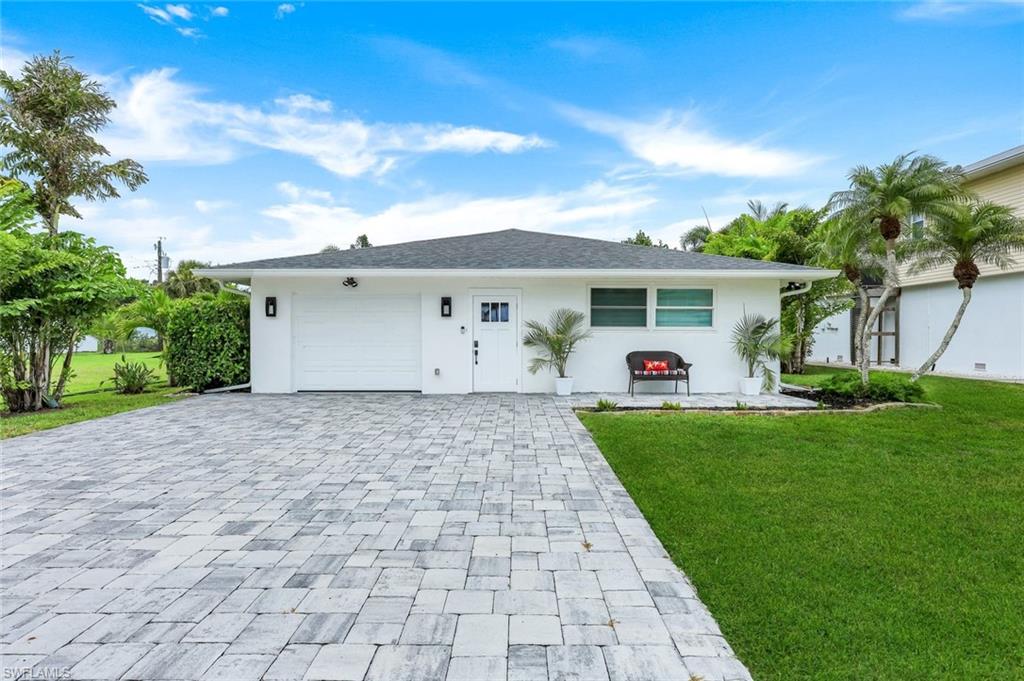 Here's a fantastic completely renovated 3 bedrooms plus den home located in the Imperial Shores neighborhood within walking distance to beautiful barefoot beach. All new throughout including all new appliances, gourmet kitchen features a huge flat island with farmhouse sink and tons of cabinetry and countertops. This spacious home offers LVP throughout, impact glass windows and doors, a luxurious primary suite with huge walk-in closet, outfitted with ceiling fans, lighting controls and window treatments plus the private backyard is fenced in.
