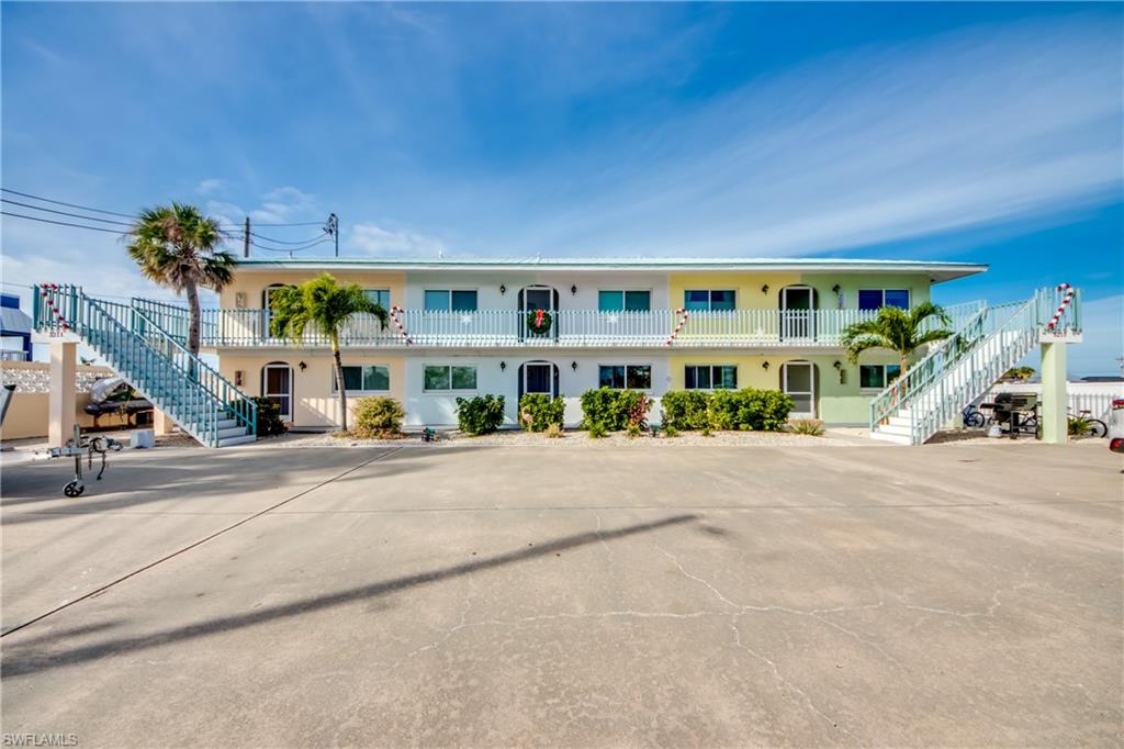 Relax and enjoy the island lifestyle in this awesome turnkey, waterfront St. James City condo. Use your deeded boat slip and floating dock to access some of the best boating and fishing in SW Florida. Sit on your screened lanai, enjoy the view of the community pool and wave at the passing boats! The condo has been completely remodeled including new cabinetry, granite countertops, ceramic wood grained tile, new appliances, new A/C, etc. Please see supplements for complete list of upgrades. Fully furnished and ready to enjoy, the unit has also been a solid income producer as a vacation rental. Begin your island adventure today!