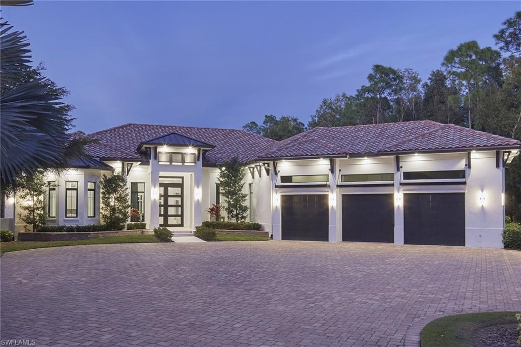 Welcome to this fully reimagined four-bedroom plus den custom estate, ideally on a rare 2.5-acre 100% uplands homesite in the heart of the exclusive Livingston Woods neighborhood of Naples. Spanning over 5100 square feet, this exceptional residence has undergone a complete, high-end renovation that blends modern sophistication with effortless indoor-outdoor living. Wood-look porcelain tile flooring flows throughout, leading into a stunning chef’s kitchen that opens seamlessly to a luxurious dining area and expansive great room. Soaring 14-foot ceilings and a sleek linear gas fireplace frame picturesque views of the tropical backyard and gas-heated pool, creating a warm yet contemporary focal point. The thoughtfully designed kitchen is ideal for everyday living and entertaining, featuring a 48-inch Sub-Zero refrigerator, six-burner Thermador gas cooktop with double ovens, Bosch dishwasher, an oversized island with Pompeii quartz countertops, under-counter XO beverage cooler, and a butler’s pantry with second sink and additional dishwasher. Two separate four-panel sliding glass doors extend the living space to a spectacular, fully screened and covered lanai. Wood-plank clad volume ceilings accent the spacious outdoor area with cozy gas fireplace, outdoor-rated Samsung TV and an impressive island bar with waterfall-edge granite countertop. The outdoor kitchen is complete with a dual-fuel gas and charcoal Coyote built-in grill, undermount sink, and stainless-steel under-cabinet refrigerator and a second Samsung outdoor TV with Sonos surround soundbar, ideal for year-round entertaining in Naples desired climate. The primary suite offers a private and serene retreat, featuring an oversized custom walk-in closet, freestanding Victoria + Albert Trivento soaking tub, dual vanities with Pompeii quartz countertops, and a steam shower adorned with decorative glass mosaic tile and rain shower head. A charming sitting area with bay window opens to the pool deck. A separate gym with LVP flooring and convenient Elkay water bottle filler completes the luxurious primary suite. Additional highlights include a private study or potential fifth bedroom, billiards room, 24-kilowatt Generac gas generator, 1,000-gallon propane tank, updated decorative entry wall and electric driveway gate, extensive landscape lighting, and a climate-controlled three-car attached garage with one car lift and potential space for up to five vehicles. Livingston Woods is known for its exceptional privacy and expansive estate homesites west of Interstate 75, all just minutes from Naples world-class beaches, top-rated schools, fine dining and premier shopping. An extraordinary opportunity to own a fully renovated estate in one of Naples desirable neighborhoods.