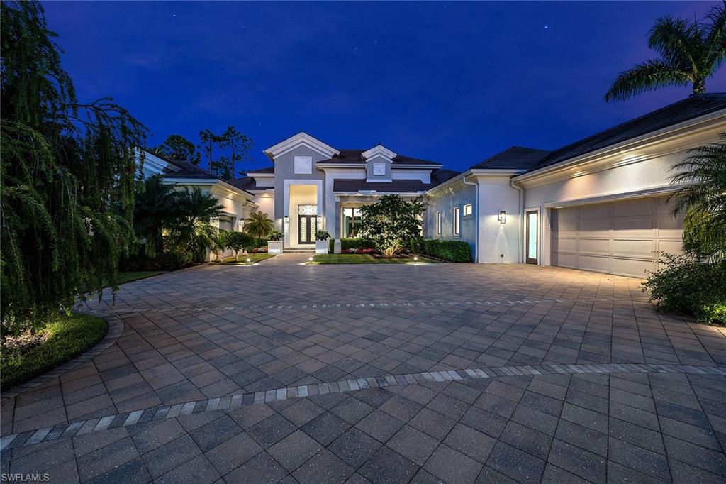 An immediate golf membership opportunity is available with this stunning home built in 2014. The rich wood floors and walls of glass create a bright and welcoming quality as you enter this home. Accentuated by wood beams, the spacious great room is flanked by windows and pocketing sliding glass doors and opens to the expansive outdoor living area. Whether enjoying the chef's kitchen featuring natural gas cooking or just a place to gather, the crisp white kitchen, which is adjacent to the great room, features a double island and is accented with a metallic grey glass tile backsplash and stunning black countertop. Designed for entertaining, you'll enjoy the convenient wet bar off the kitchen or cooking at the outdoor kitchen featuring a top-of-the-line grill. This is Florida living at its best with extensive covered outdoor spaces and custom swimming pool. Additional features include a smart home lighting system, two laundry rooms, an outdoor shower off the master bath and more. Have it all with this home located in the award-winning community of Mediterra including 36 holes of Tom Fazio golf, pickleball, tennis, a private beach club and more!