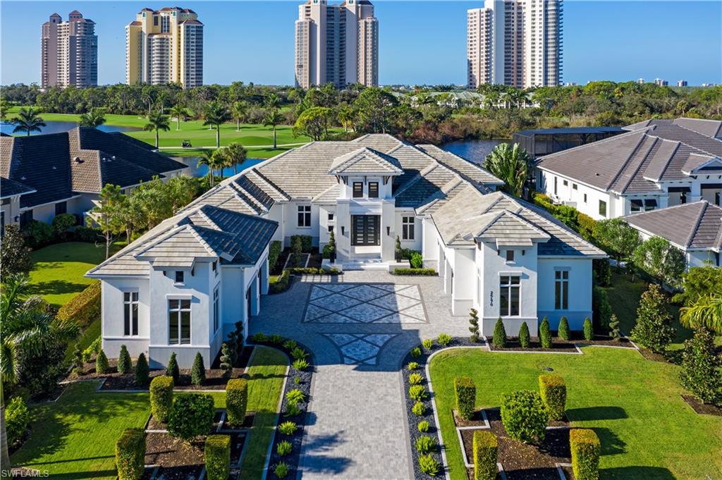 Luxury and sophistication are combined with world-class craftsmanship to deliver this award-winning STOCK custom home in the exclusive Bay Woods at Bonita Bay. Thoughtfully designed by New Architectura in collaboration with Wilfredo Emanuel Designs and Clive Daniel, this Cosmopolitan Chic home was the winner of the prestigious Sand Dollar Award and boasts a nearly $1,000,000 interior design package. Situated on a premium lot with unobstructed lake and golf course views, this home boasts 4 bedrooms, 6 bathrooms, bonus room, and an oversized 4-car garage with room for 5 plus cars. As you enter through the grand contemporary steel doors, you are immediately struck by the dramatic geometric ceiling details, white glass tile flooring, suspended lighting, illuminated quartz wine bar and glass-enclosed wine room. The Cosmopolitan theme is carried into the kitchen, featuring glass-faced cabinetry, quartz and semi-precious stone islands with waterfall, Wolf and SubZero built-in paneled appliances, Miele coffee machine, a walk-in pantry and more. The massive primary suite is nothing short of breathtaking. From its white oak flooring to the oversized seating area, dual walk-in closets, mirrored wall panels, textured wallpaper and built-in headboard with custom lighting. As you enter the primary bathroom, you will find two separate water closets, a free-standing tub, oversized shower with multiple heads, gorgeous tile and textured accent walls. Boasting more than 3,000SF of space, the outdoor area is a true focal point of the home and features countless upgrades such as electric shutters and screens, bug mist system, gas fireplace and separate fire pit area, massive outdoor kitchen with waterfall quartz counters, geometric ceiling details, white marble pavers, and pool bathroom. Enjoy the sunset views over the infinity edge gas-heated pool and spa. Continuing throughout the home, you will find that every guest bedroom is ensuite and features white oak flooring, walk-in custom closets and each has its own unique design cues such as custom draperies, wallpapers, ceiling and wall details. Showcased by a floor-to-ceiling glass entry, the opulent billiards/bonus room is sure to impress with its custom leather-padded wall and illuminated stone accents. The full-home Control4 smart system provides automated electric blinds throughout, smart lighting switches, indoor and outdoor built-in speakers, security system and more. Bonita Bay offers an array of outstanding amenities and optional memberships, from a private beach club to a full-service marina and multiple dining options. Experience premier golfing with five recently renovated Arthur Hills and Tom Fazio championship courses and three expansive practice facilities. Enjoy miles of scenic walking and biking trails, kayaking, canoeing, boat launch, state-of-the-art fitness center, an 18-court tennis and pickleball complex, numerous community parks and more.