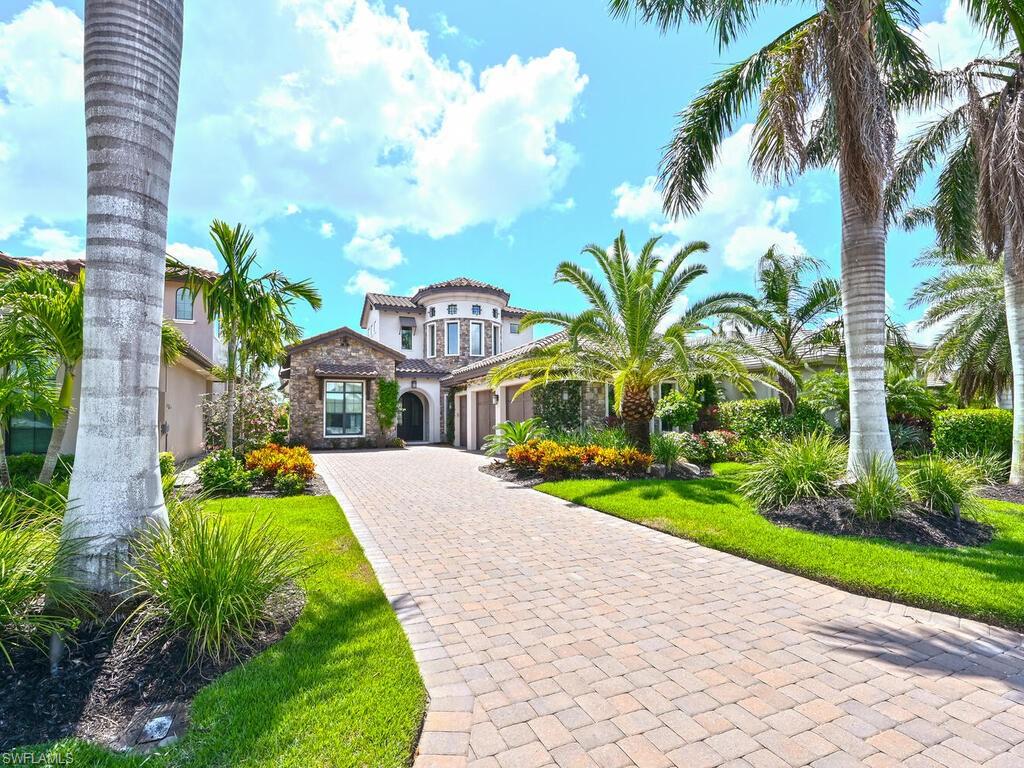 Exceptional waterfront home in Miromar Lakes designed & furnished with utmost elegance. Main floor boasts mstr suite with sitting area, luxury bath & walk-in closet.  En-suite gst bdrm provides privacy. Den with stylish barn door is serene space to work/relax. Chef's kitchen, dining & living showcase beautiful view.  Powder bath accessible to  pool & laundry room complete main floor. Magnificent foyer spiral staircase leads to partial 2nd story with en-suite bdrm, bonus room & private balcony. Addl room has bunk beds with option to add elevator.  Step outside to the fabulous lanai complemented by outdoor kitchen, gas grill, large pool/spa with sun shelf, mesmerizing waterfall & gas fire pit.  Sand beach with view of marina with docks to lease.  Upgrades that further enhance luxury: 3 car gar with ac & new epoxy floor, central vac, sonos home audio, air purification system & more.  Miromar Lakes is close to RSW Airport, FGCU & multitude of venues.  Over 700 acres of freshwater lakes, amenities offer myriad of water sports, miles of sand beaches, I/O bars & dining, theater, library & more.  Bocce, tennis, pickle ball, fitness center, spa & optional golf offer unparalleled lifestyle.
