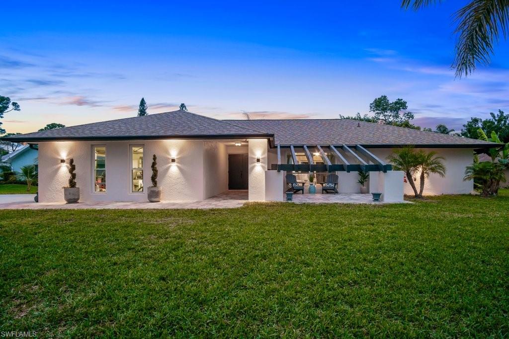 BACK ON THE MARKET - BUYER'S FINANCING FELL THROUGH. This completely updated home on a private cul-de-sac in the North Naples River Oaks community sits on nearly half an acre! Just minutes to Florida's white sand beaches, Mercato, The Ritz Carlton, & local attractions, enjoy the Florida lifestyle. Ready to move in, everything has been updated, nothing left to do! This home has so many architectural touches-dark wood beams, & the wood-burning fireplace finished with stunning dark stone accents the cozy sitting area which leads out to the spacious lanai seating area & pool/spa, ideal for entertaining, dining, & relaxing. The large formal living room area is flooded with light. Kitchen updates include S/S appliances, new S/S range hood, tile backsplash, kitchen counter seating, & large island - this home was made for entertaining! The master bedroom w/ updated bath & walk-in closet has sliders opening to the lanai. 2 additional spacious bedrooms are off the fireplaced sitting area & share an updated full bath with tub/shower. Laundry room off the kitchen leads to the 2-car garage. New roof in 2019, impact windows & front door in 2019. No HOA or rental restrictions! Move in or invest!