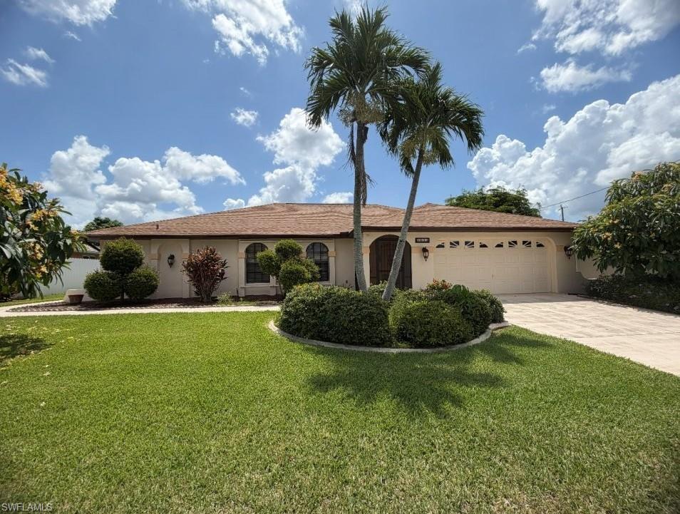 INCREDIBLE PRICE for an INCREDIBLE LOCATION!  This NON-AE FLOOD ZONE POOL HOME (flood insurance not likely required!) is nestled in a beautiful neighborhood of Gulf-access homes and is just steps away from the old city-owned country club, which will soon be a public park/ greenspace!  With CENTRAL UTILITIES and ALL ASSESSMENTS PAID, this home features an open floorplan with a central island kitchen separating the living room and formal dining/ family room, and offers SPLIT BEDROOMS.  Situated around the SCREENED-IN pool deck, the floorplan delivers multiple accesses to the large shaded and sunny outdoor living space via sliders in the large primary suite and living room, as well as POOL ACCESS to the guest bathroom.  Located in a quiet, but central area of the city, this property is just minutes from shopping, groceries, restaurants, and everything you need to enjoy the perfect SW Florida lifestyle!  Don't miss this opportunity and schedule a private tour today!