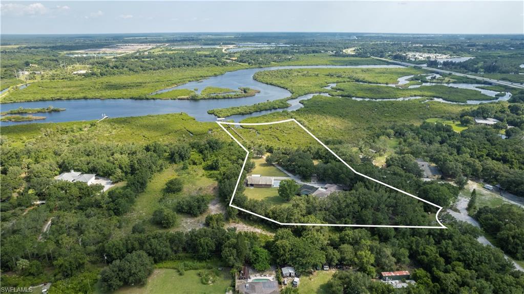 Spacious Country Home w/5.03 Acres on Beautiful Shell Creek, w/Direct Access to Charlotte Harbor/Peace River & Gulf, enjoy Boating, Fishing, Kayaking from your private Dock w/a 6,000lb Covered Boat Lift.  The Attention to Detail is evident from the Gated Front entrance, Tree Lined Drive, you will note this is a One of a Kind Home, Featuring a Spacious 4Bed, 3Baths, Great Room w/Custom Details, Front Door, Walnut Live Edge Shelves, New Mantle & Beams, Open Kitchen w/Top of the Line Appliances, Double Oven, 36"Induction Cooktop & 5Door LG Frig, Custom Maple Cabinets w/Drawer Dividers, New Sink/Faucet, Stone Counters w/Edge Grain Cutting Board & Tile Murals, Split Floor Plan w/Private Owners Suite w/New Cabinets, Walnut Slab Counters, Lighting, Flooring & Custom Designed Shower w/Stone Mosaic, Screened Lanai & Pool Area w/Summer Kitchen, Outdoor Shower along w/a Dog Wash Station.40X55 Detached Barn/Workshop, take a Walk to your Private Boat Dock on Shell Creek, Offering Graceful Country Living just a Short Drive to Shopping, Dining, Downtown Punta Gorda, I-75, Punta Gorda Airport, Waterfront Parks, Tennis, Golf, Pickleball, Port Charlotte, Arcadia & all that Southwest Florida Offers