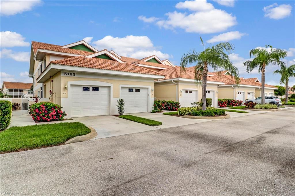 Very spacious lake view home in a wonderful North Naples location. BRAND NEW ROOF is scheduled to be completed next month and it is all paid for !! End unit with 2 large screened lanai !! Tall ceilings. Attached garage. Plenty of guest parking.  Heated pool and lots of great amenities at Carlton Lakes.