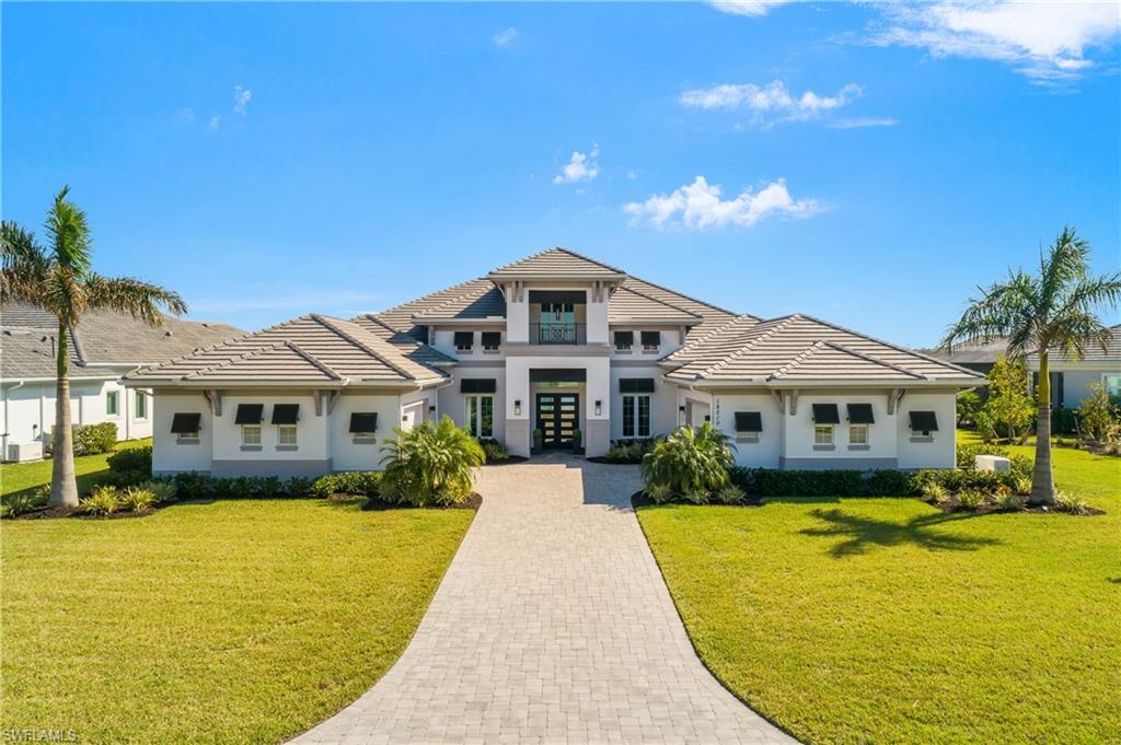 Luxury Lakefront Living in Wildblue!
Welcome to an unparalleled lifestyle in the prestigious enclave of Blue Eye Loop at Wildblue. This exquisite lakefront residence, a Clairborne II floorplan, offers 4,381 square feet of thoughtfully designed interior living space which seamlessly blends with an expansive outdoor living area. 
A Water Lover's Dream--Situated on the shores of Wildblue's pristine boating lake, this home boasts breathtaking water views from both the front and rear, perfectly capturing the beauty of the natural surroundings. A private dock provides easy access to the lake, ideal for boating enthusiasts seeking serene escapes or lively water adventures.
Step inside to discover a meticulously curated home with designer touches in every detail. The great room features coffered ceilings with wood accents, a stunning designer chandelier, and a custom feature wall adorned with lighted bookcases and additional storage. The expansive kitchen is a chef's dream, anchored by a vast island and equipped with JennAir professional-grade stainless steel appliances, a walk-in pantry with custom shelving, and sleek cabinetry. The luxurious master suite is a haven of tranquility, offering a spa-inspired bath with a soaking tub, a large walk-in shower, dual vanities, and his-and-her walk-in closets outfitted with custom built-ins. Each of the four bedrooms is complemented by its own full bath, plus an additional powder room. Custom window treatments throughout add elegance and privacy. The outdoor living space is designed for relaxation and entertainment, featuring an outdoor kitchen, a large bar area, and a built-in gas fireplace. Enjoy al fresco dining with unobstructed views of the boating lake and a protected preserve, a perfect backdrop for gatherings or quiet evenings under the stars. Home is offered FURNISHED and comes equipped with a whole home generator for peace of mind in any storm. You'll LOVE the Extraordinary Lifestyle in Wildblue. This home is more than just a luxurious residence—it's a lifestyle. Indulge in dining and socializing at Wildblue, with the convenience of an onsite indoor restaurant and an outdoor lakeside bar and grill. Partake in a wealth of community activities year-round--from pickleball and tennis to bocce and countless entertainment opportunities. You'll LOVE Wildblue where every detail of your lifestyle is tailored to perfection. Your Southwest Florida dream home awaits in Wildblue!