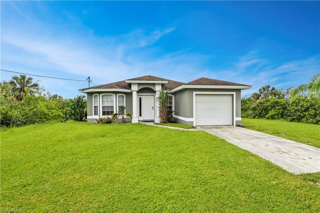Great opportunity to own a home with an Old Florida setting! Situated on almost 2 1/2 acres in the growing NW part of Naples, this 3 bedroom home has a traditional split bedroom floor plan and offers over 1,100sf of under air living space. The kitchen has dual entry (one from each side of the home), a service window to the lanai, and all appliances are only 5 years old. A new Carrier a/c unit was installed in 2015 and features a UV light along with a photocatalytic oxidation PCO PhotoMax which improves the air quality immensely. Offering $1,500 flooring allowance.  There is plenty of room to or all of your toys, and definitely enough land to add a work shed/detached garage, a pool, and/or fire pit area if desired. The land backs up to a canal and is partially cleared (front end). Located just off of Immokalee Rd with easy access to I-75, and close to lots of shopping & dining options. You will love having all the conveniences of city life while enjoying the quiet country life as well!