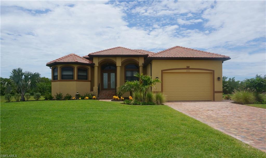 This custom built 2050 sq ft 3 bedroom home was constructed by Paul Homes in 2015 on an oversized private lot. Inside the custom entry doors with bamboo glass insets, you will discover an open great room concept with 14' tray ceilings accentuated by tasteful crown moldings. Striking columns frame the entrance to the main living space which features tasteful fans & fixtures, illuminated accent niches and custom built ins. Diamond set tile is carried throughout the home with disappearing sliding doors connecting your indoor and outdoor living space. The kitchen and baths are finished with warm wood cabinetry and granite tops. The spacious master suite offers a tray ceiling and sliders to the lanai. You are sure to linger in the sun-filled master bath featuring a roman shower with bamboo glass, inviting soaking tub, dual sinks and his/her closets. Enjoy fiery sunsets from your screened in lanai with paver flooring. There is plenty of room to add a room in the future. Store your boat or your toys in the oversized garage. Furniture package available for purchase separately for $8,900.
