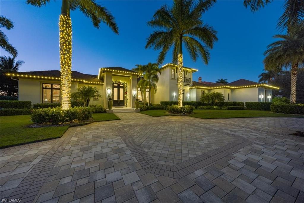 GOLF MEMBERSHIP AVAILABLE IMMEDIATELY! An impeccable balance of indoor/outdoor living is immediately evident as you cross the threshold of this stunning Diamond-built home. A contemporary palate of crisp whites, chromes and chocolate tones blends harmoniously with the sweeping views of the golf course and water for a perfect FL lifestyle made accessible from a full wall of doors leading to the spacious lanai. Nothing but the finest detailing is apparent throughout including custom built-ins coffered ceilings, gleaming marble flooring plus new state-of-the art AV system, home automation and wine storage. The lanai offers generous covered seating areas, outdoor fireplace, fully equipped kitchen, custom infinity edge pool, serene spa & views! The heart of the home is the spacious gourmet kitchen with walk-in pantry plus appliances and details any cook would covet - all opening directly to the family room and lanai. The master features dual custom walk-in closets, custom shoe closet plus his & hers bathrooms. The guest bedrooms are perfectly placed for privacy too. Set on almost an acre of land, this home also features a 4-car garage & whole home generator to complete the checklist.