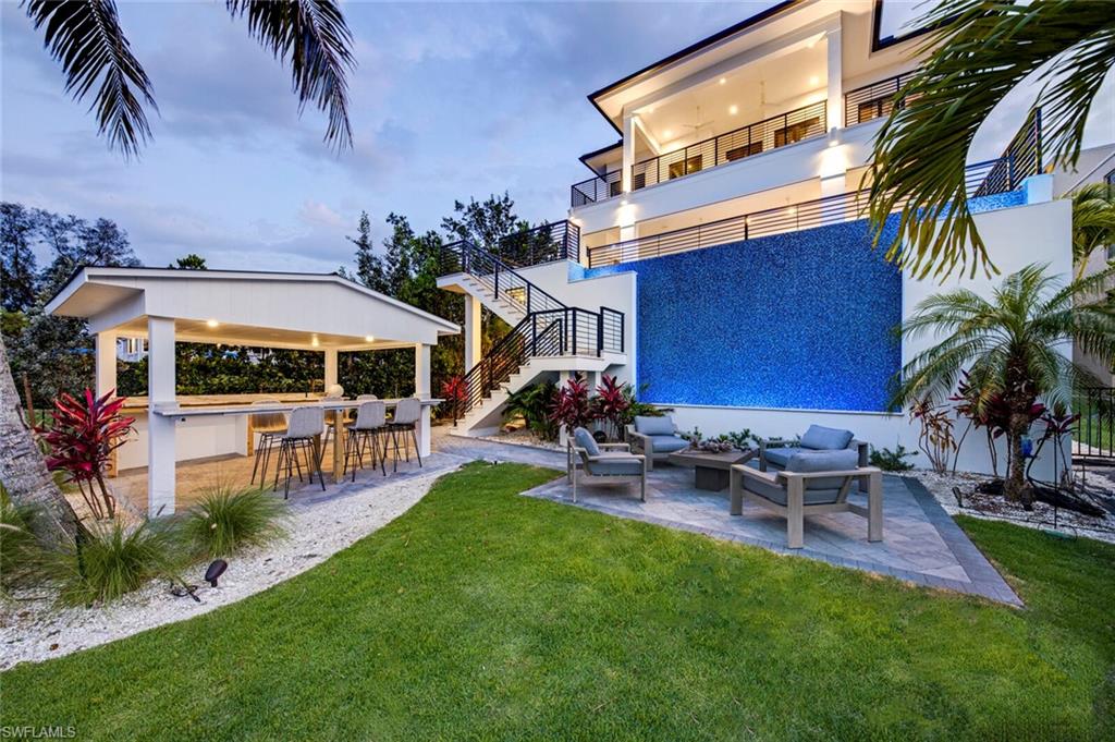 For a thorough tour, be sure to click the video. Beautiful views of the Gulf in front and wide Bay views and your boat docks and Tiki bar in back; there is simply no other Bonita Beach residence quite like this. A two year project. completed by Diamond Construction in 2020, appointed with the finest selections throughout by Naple’s choice designer, Kriss Lecocq. Features include wireless custom blinds, impact glass and sliders, retractable lanai screen, retractable hurricane lanai shutter and so much more.  Whether inside the home, on one of the many lounging lanai's, the relaxed elegance will be there for you and yours. The air conditioned living area in total is  over 5,744 sq.ft. Enjoy the photos and the video, seeing it live only further impresses the beauty of this incredibly furnished, ready to be enjoyed, modern coastal estate.
