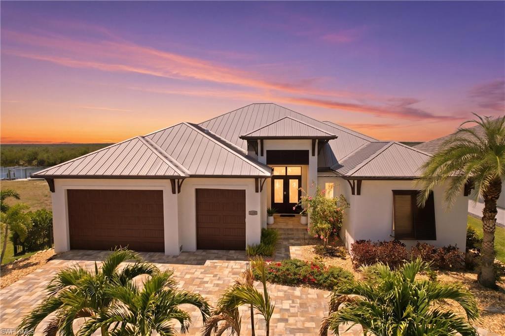 3100 Surfside Blvd Cape Coral 33914 DIRECT GULF ACCESS WESTERN EXPOSURE PRESERVE VIEWS MINUTES TO THE CALOOSAHATCHEE RIVER One of a kind custom waterfront estate designed to blur indoor outdoor living built from the outside in to capture breathtaking unobstructed western sunsets over a protected preserve This home delivers the Southwest Florida lifestyle with sunshine boating gulf access and nearby sandy beaches where days are spent on the water fishing cruising or relaxing and evenings end with panoramic skies and warm coastal breezes
From the moment you arrive the quality craftsmanship is clear A striking custom metal front door with remote shade opens to a thoughtfully designed floor plan maximizing natural light views and flow Every space enhances comfort privacy and functionality while keeping the focus on the outdoor living experience and water views
Luxury finishes throughout include a chef’s kitchen with 6 burner gas range pot filler wall oven microwave exotic granite island with accent lighting black granite counters custom cabinetry ceiling cabinet lighting and abundant storage A walk in butler pantry with wine cooler and freestanding ice maker creates a true prep and entertaining space ideal for hosting Main living areas feature crown molding tray ceilings and 10 inch baseboards Plantation shutters throughout add timeless style Impact windows and doors with remote controlled security and sun screens provide convenience and peace of mind All bedrooms are en suite offering privacy for family and guests A private office with shared bath and direct pool access adds flexibility Custom laundry room with front load washer dryer and built in storage enhances everyday living The primary suite is a private retreat featuring a cedar coffer ceiling and spa inspired bath with mother of pearl tile massage stone shower floor dual vanities and under cabinet lighting creating a relaxing atmosphere Seamless indoor outdoor flow with 10 foot sliders and a dramatic 90 degree corner opening leads to an expansive lanai with granite countertops gas grill dishwasher and picture window screen enclosure preserving unobstructed views of the preserve and waterway Resort style outdoor living includes a saltwater vanishing edge pool beach shelf entry oversized spa and generous deck space Western rear exposure provides sun filled afternoons and unforgettable sunset views that define the Southwest Florida lifestyle Boater’s dream with NEW composite deck dock and lift offering quick direct gulf access and only minutes to the Caloosahatchee River allowing easy access to open water beaches waterfront dining and island destinations
Additional features include newer metal roof 400 lb compressed pavers pet fencing and custom lighting throughout
Luxury location lifestyle and design come together in this exceptional property.