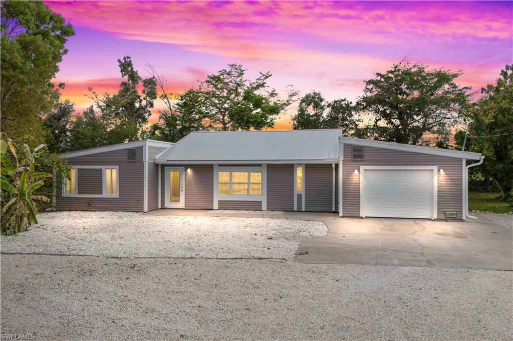 over 2,000 SQUARE FEET AND AN ACRE - plenty of room to add in a barn, detached garage and pool! Welcome to your private Pine Island sanctuary! This 3BR/2BA Bokeelia home sits on over 1 acre of beautifully secluded land, offering the perfect blend of privacy and comfort. Surrounded by nature, this property delivers the relaxed island lifestyle you’ve been searching for. The home has been updated with a NEW metal roof and a gorgeous kitchen featuring granite countertops and almost new appliances. Inside, the spacious open-concept floor plan is highlighted by soaring cathedral ceilings, abundant natural light, and a desirable split-bedroom layout for added privacy. The expansive kitchen and family room create an inviting space for entertaining or quiet evenings at home. The primary suite serves as a peaceful retreat with a well-appointed bath offering twin pedestal sinks and a walk-in shower. Two additional bedrooms and a full bath provide flexibility for guests, family, or a home office. Outdoors, enjoy a large front yard, mature fruit trees, and a separate outbuilding ideal for extra workshop, storage, or creative space. Plenty of room for boats, RVs, gardening, or simply enjoying the serene surroundings. Quiet, private, and truly one-of-a-kind—this property captures Pine Island living at its finest. HUGE living space and located in a quiet part of the island yet still close to everything!