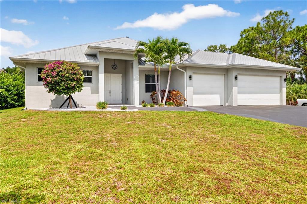 Some homes are just addresses. This one is a way of life. Set on 1.25 high and dry acres at the very end of Claire Street in the coveted no-HOA enclave of San Carlos Estates, this 2018-built 4-bedroom, 3-bathroom ranch offers 2,482 square feet of thoughtfully designed living where the pavement ends and true privacy begins. NEW LANDSCAPING THIS WEEK!  A canal borders one side of the property with no neighbors and no pass-through traffic — just the kind of stillness that Southwest Florida buyers spend years searching for. Zone AG2. Flood Zone X. Horses welcome. No flood insurance required. No compromises. Inside, Coretec luxury vinyl plank flooring runs on the diagonal throughout every room, giving the home a sense of elevated design from the moment you walk in. The bathrooms are a true retreat — clad in marble and thoughtfully designed with bespoke finishes that bring a five-star resort sensibility to everyday living. The entire home is plumbed with PEX and topped with a metal roof with blown R30 attic insulation, built to stand up to Florida's demands for decades to come. The garage features epoxied floors and a Tonal smart gym that stays, so your fitness routine never has to leave the property. New LG Matte Black washer and dryer let you schedule your laundry from your phone. Step outside and the lifestyle only gets better. The heated pool was installed in 2020, drops to a full 6-foot depth, and is surrounded by a 1,154 square foot screen enclosure and brick patio — your own private resort at the end of a quiet street. Full property irrigation keeps every inch of your 1.25 acres lush and green year-round, and a 30-amp RV hookup with water at the rear of the property means your guests, your rig, and your weekend adventures always have a home base. The front entrance to San Carlos Estates will soon border the Bonita Estero Rail Trail, a funded 14.9-mile multi-use path connecting Bonita Springs and Estero through 95 percent forested corridor — walk, run, or bike from your front door into one of the most anticipated public projects in Southwest Florida history. Trail-adjacent homes command a 4 to 11 percent price premium nationally and you are buying ahead of that curve. Eight miles to Bonita Beach, four miles to Coconut Point, minutes to I-75 and RSW Airport. This is Bonita Springs living on your own terms.