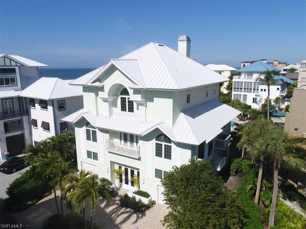Island style direct gulf front home on Barefoot Beach. This recently renovated beach home offers an interior update as well as exterior renovations including stucco finished exterior, impact glass, new roof, and whole house generator. Rare opportunity to get a property so close to the beach for the price point. 6 bedroom layout. The main level of this home offers a relaxed island style offering hardwood flooring, feature mantel, and sweeping Gulf views. Also features open kitchen with island layout and high end appliances. Covered lanai with screens and electric shutters as well as a rare direct beach stairway. Grand beach front master suite with large bath offering shower, tub, and his and her vanities. The guest suites are all well appointed offering stunning views and/or step out lanais. Private elevator. Large beach living area with kitchenette. Covered beach lanai perfect for storing the beach toys. Barefoot Beach Gulf homes include private pool, clubhouse with fitness, har tru tennis courts, pickle ball courts, 24 hour security and patrolled. Optional boat dock across the street and full service club at Barefoot Beach are available.