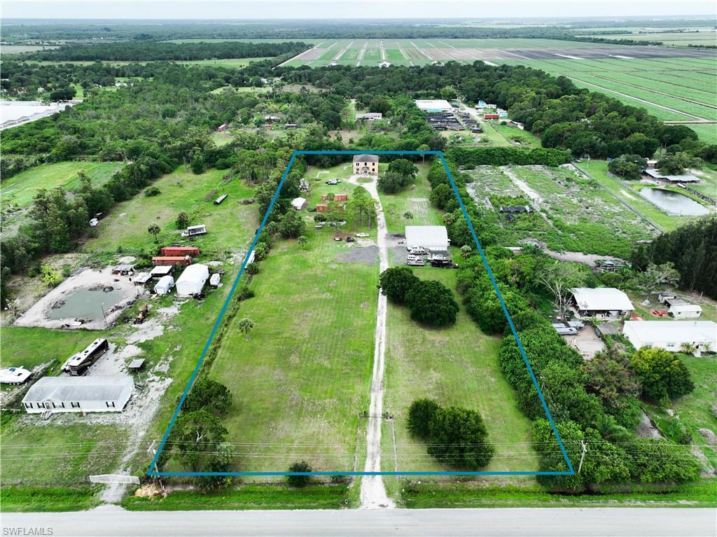 Experience the perfect blend of country living, functionality, and versatility on this exceptional fully fenced estate, tucked away in a peaceful rural setting surrounded by expansive farmland. A solar-powered entry gate welcomes you to the property, offering both convenience and privacy while setting the tone for everything this unique offering has to provide.



Boasting nearly 4,000 square feet of living space, the home features 4 bedrooms and 4 bathrooms thoughtfully designed to accommodate both everyday living and multi-generational lifestyles. A standout feature is the attached efficiency apartment/mother-in-law suite, complete with its own full kitchen and bathroom, providing the ideal setup for extended family, guests, or potential rental income while maintaining independence from the main residence.



The spacious second-floor primary suite serves as a private retreat, featuring its own balcony overlooking the property and picturesque rural surroundings. The suite also offers dual closets and a custom-designed bathroom complete with two toilets, a soaking tub, and an oversized walk-in shower, creating a luxurious and highly functional owner’s sanctuary.



For those seeking serious workspace, the impressive 50’ x 50’ workshop is equipped with high ceilings, 200-amp electrical service, a 10,000-pound vehicle lift, and a commercial-grade air compressor, all included with the sale. Whether you’re an automotive enthusiast, business owner, craftsman, or collector, this space offers endless possibilities.



Outdoor amenities continue with a private pond, a substantial 16’ x 32’ chicken coop, and abundant open acreage suitable for livestock and agricultural pursuits. Horses are permitted, making this property an ideal homestead, hobby farm, or equestrian retreat.



Whether you’re looking for a private country estate, a property that supports your business ventures, room for animals, or a flexible multi-generational living arrangement, this remarkable property offers a rare combination of comfort, utility, and rural charm with plenty of room to grow, work, and enjoy the Florida lifestyle.