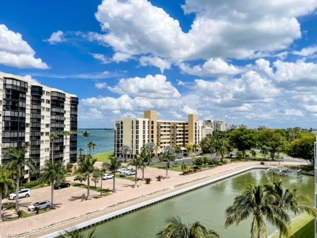 PENTHOUSE! Top floor corner unit CASA MARINA!!  AND, YES, THIS VIEW HAS THE SUNSETS EVERYONE LOVES!!  Wow views of Estero Bay from this 5th floor 2 bed / 2 bath condo! Views include expansive bay view, canal for dolphin and manatee visits, and a view of the gulf from your kitchen and dining area!  Oversized  for this building, you'll enjoy the almost 1,300 square feet with extra wide under-building deeded parking spot. Kitchen is completely reconfigured providing a modern open floor plan with island, Corian counters, bar seating, pantry, lots of storage and separate dining area with special effects lighting! NEW washer/dryer 2019 (Located in closet on lanai) and dishwasher in 2019.  Electric shutters on the lanai, all other windows have manual shutters.  Start enjoying the amenities: pool, deeded beach access, fishing pier, and tennis. Walk a few a minutes to reach the beach! Great location with restaurants, marina, Lover's Key State Park, walking paths, and Casa Marina has gulf access boat docks available for rent or purchase.