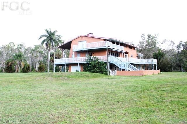 Really Neat Florida Style Pool Home located on 1 acre with 3,420 sq ft under air. This 3 Bed/2 Bath home with Den has tons of oppotunity. New Roof in 2004 and New A/C in 2012. Huge wrap around front porch that goes around the entire home perfect for entertaining. The garage holds 3 cars with additional under building parking and pass through garage door. Island kitchen, breakfast nook, 3 fireplaces, formal lving, dining and family room. CENTRALL LOCATED TO EVERYTHING: 10.25 mile/18 min.to Fort Myers Beach. 14.59 Miles/24 min. to Sanibel Island. 6.6 Miles/13 Minutes to Gulf Coast Town Center.  10.37 Miles 18 Minutes to RSW Airport