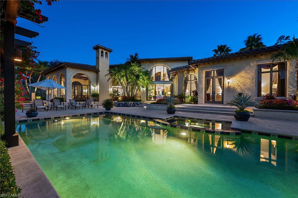 Immediate golf membership opportunity available! This custom home with its timeless details and architectural style reminiscent of the Italian countryside embodies elegance and simplicity. Perfectly situated on over an acre of land, enjoy spectacular private views over lake, golf course, and preserve. Drive through the bougainvillea-adorned porte-cochere that leads to a four-car garage motor court. Then, as you enter the home through the custom hand-scraped double doors, you are greeted by a soaring wall of glass in the two-story living room overlooking the pool. The study, with room for a spacious desk as well as additional seating, features a rich wood coffered beamed ceiling as well as French doors that lead to an intimate courtyard with vine-covered walls, that create the perfect retreat. Walk through the gallery past the walk-in wine cooler to the family room, which is flanked by the kitchen and breakfast nook on one side and opens up the expansive outdoor living area on the other. Additional features include a home theater, stone flooring, wood beam ceilings, a lighting control system and more. Truly exceptional! Located in the award-winning community of Mediterra.