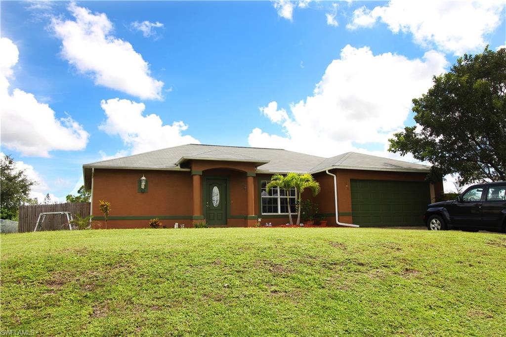 Splendid 3 bedroom 2 bath home in quiet neighborhood of NW Cape features a split floor plan with vaulted ceilings, tile throughout, large walk-in closet, dual sinks in master, separate slider from master to the lanai, newer interior and exterior paint, new deck in the back yard, above ground pool, fully-fenced back yard, and a screened-in lanai.
