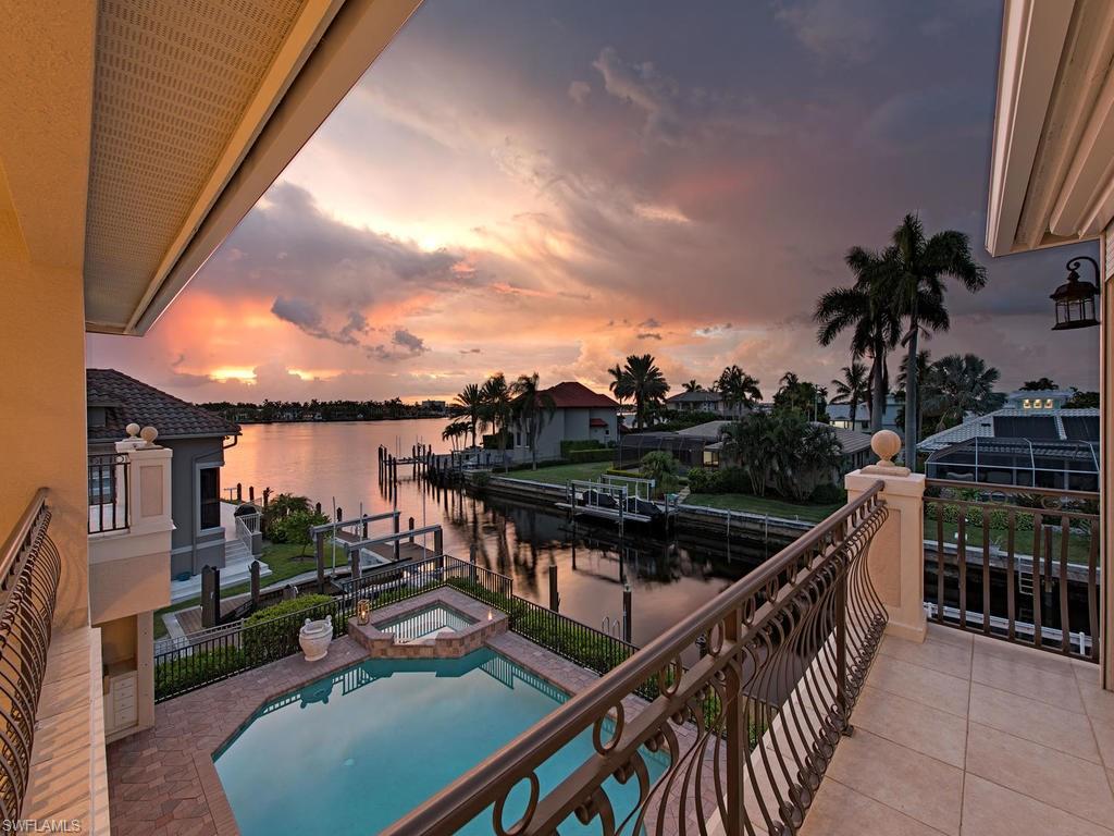 Boater’s Paradise! This elegant waterfront home has magnificent European charm inside & out. Your private boat dock & lift in a deep canal puts you only minutes from Naples Bay and the inviting waters of the Gulf. This stately home boasts vaulted ceilings,large windows/sliders allowing abundant natural light, and a vast ground floor master suite. A gas range adds to a superior cooking experience in your gourmet kitchen flowing into a spacious family room complete with fireplace. 2nd floor includes loft area with wet bar & built-ins, & two sizeable guest bedrooms, with balconies perfect for watching spectacular Naples sunsets. Bay & canal views surround you while lounging in your pool or entertaining in your outdoor kitchen. As you approach, your circular paved driveway, mature landscaping & rich wood doors invite you inside this impressive residence. Bonus features include a protected dock and electric storm shutters. Pristine sandy beaches are only a short bicycle or car ride away. Minutes from your home are the best places to dine and shop anywhere in Old Naples. Or simply stay home for your own personal nightly sunset showcase. Allow us to arrange for your private showing today!