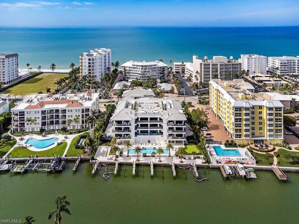 New Construction Bayfront!  Luxuriously furnished and decorated residence representing the epitome of coastal elegance and offering panoramic views of Hurricane Harbor and includes deeded boat slip with large pets are welcome. Step off the elevator into your private foyer that opens into this stunning 3-bedroom haven, each bedroom boasting its own en suite bath for ultimate privacy. The residence radiates elegance, from the Legno Bastone white oak flooring to the selection of exquisite fixtures. The gourmet kitchen is a culinary enthusiast's dream and is equipped with high end Wolf & Sub-Zero appliances. Spectacular outdoor amenities include a geothermal heated pool with sun shelves and lap lane, heated spa, two cabanas for grilling and relaxing and an inviting putting green. Enjoy sunsets and social gatherings at the rooftop courtyard. La Perle, built to transcend time, has emerged as a coveted sanctuary in a prime location conveniently located near Naples' illustrious shopping and dining venues, including Venetian Village, Waterside Shops and Lowdermilk Park. A short drive or bike ride to Old Naples and 5th Avenue ensuring La Perle’s residents enjoy the best of Naples' lifestyle.