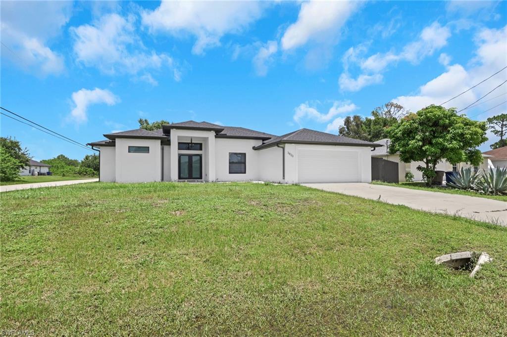 Welcome to this beautifully designed 4-bedroom, 2-bathroom newer construction home situated on a desirable corner lot in Lehigh Acres. Conveniently located near I-75, SR-82, Daniels Parkway, shopping, dining, schools, and Southwest Florida International Airport, this home offers both comfort and accessibility. 
Step inside to an open-concept floor plan featuring soaring high ceilings, oversized porcelain tile throughout, abundant natural light, and contemporary finishes. The spacious gourmet kitchen is the heart of the home, showcasing an oversized center island with seating, quartz countertops, stainless steel appliances, custom cabinetry with additional storage, a stylish backsplash.

The thoughtfully designed split-bedroom floor plan provides privacy, while the spacious primary suite features a well-appointed en-suite bathroom and dual walk-in closets, offering generous storage and convenience.
The dedicated laundry room includes built-in cabinetry and a utility sink, making everyday chores more efficient.
Enjoy Florida living year-round on the expansive covered lanai complete with a built-in outdoor kitchen, perfect for entertaining family and friends. The fully fenced backyard offers privacy and includes a convenient gated side entrance, providing easy access for lawn equipment, trailers, pets, or outdoor activities.

Additionally this home includes a two-car garage, modern lighting and fixtures, extra kitchen cabinetry, and exceptional curb appeal. Located just minutes from major roadways, shopping, dining, schools, and everyday conveniences, this move-in-ready home offers the perfect combination of style, functionality, and location.
