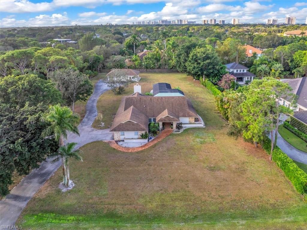 Perfectly positioned in one of Naples’ most desirable central locations, this generous homesite at 561 Ridge Drive offers a rare opportunity to create a custom luxury residence in the highly sought-after Pine Ridge neighborhood. The property sits high and dry in a preferred X flood zone with an impressive 17FT elevation, an exceptional characteristic that enhances both peace of mind and long-term value. Set on a 1.2-acre lot with preferred southwest exposure and excellent site orientation, the property provides an ideal canvas for a new build tailored to today’s modern lifestyle. Although a home currently occupies the site, the offering is presented at lot value as a premier teardown opportunity for a future custom estate. The dimensions and orientation of the property readily accommodate a substantial single-family residence with resort-style pool, expansive outdoor living areas capturing beautiful afternoon light and sunset skies, and a multiple-car garage, all while maintaining privacy and abundant green space. Just minutes from Naples’ renowned white-sand beaches, Waterside Shops, Mercato, and an array of fine dining and entertainment options, this location combines a quiet residential setting with exceptional convenience. For discerning buyers and builders seeking a high-quality, southwest-exposed site on city water in a blue-chip Naples neighborhood, 561 Ridge Drive represents a compelling and increasingly scarce opportunity.
