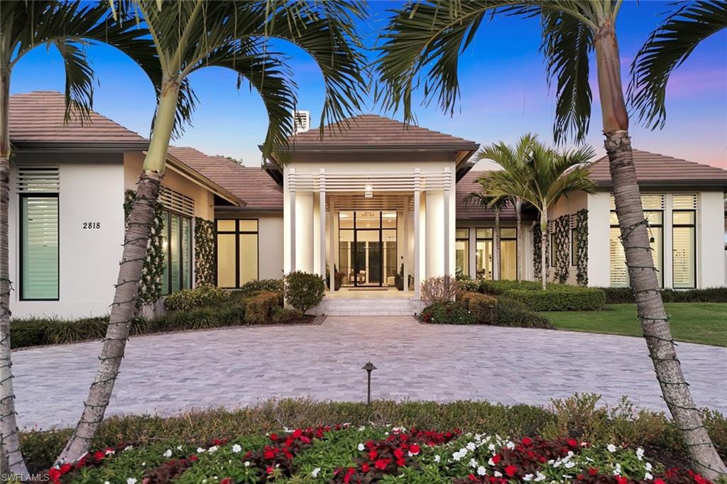 Nestled on a private and serene .73-acre lake-view cul de sac homesite within the prestigious Estates section of Grey Oaks Golf & Country Club, this single-story luxury estate built in 2021 by Diamond Custom Homes, artfully designed by Stofft Cooney Architecture, with interior design by Collins and Dupont, presents an unmatched fusion of contemporary design and resort-style living. Expansive glass doors and windows flood the interior with abundant natural light and a seamless indoor-outdoor flow framing picturesque lake and garden vistas.Inside, the residence spans over 6300 square feet and is graced by an elegant palette of premium finishes and custom detailing.Legno Bastone french oak wood floors adorn the interior, while polished nickel fixtures and quartzite and marble countertops imbue the space with refined character.The 14' volume ceilings boast impressive custom backlit treatments adding ambiance to the spacious split living area.The gourmet kitchen is appointed with custom cabinetry and top-of-the-line appliances, including dual Miele dishwashers, Sub-Zero refrigeration, a 48" Wolf gas cooktop, wall ovens, and steam oven.Entertaining is effortless, with features such as a hidden walk-in pantry, an integrated coffee bar, and a wet bar complete with ice maker and dual beverage drawers. A generously proportioned center island, topped with Carrara marble, offers ample workspace and casual dining. A wine bar and glass enclosed, climate controlled wine closet add to the entertaining experience. Adjacent to the kitchen, an enclosed flex space den with custom cabinetry, quartz counters, and extra workstation, presents an opportunity for a second office, workout room, or media/theater space. This den hosts a wall of french doors leading to a secluded outdoor patio space, an ideal nook for intimate conversation or quiet reflection. The luxurious primary suite features oversized picture windows framing a cozy seating area, a sumptuous marble-appointed bathroom, built in wet bar, and extensive custom closets.  Outdoor living is at its finest where tumbled Carrara marble tiles surround the infinity-edge pool with integrated spa.The expansive covered living area features generous spaces for both alfresco dining and lounging beside the outdoor kitchen, gas fireplace, versatex ceilings, retractable screens, and a rainfall detecting auto hurricane shutter system for peace of mind. A convenient pool bath serves outdoor guests, while a cozy fire-pit lounge, detached pergola, and an ample pet friendly fenced grass area finish this exceptionally functional space.This extraordinary property, blending sophisticated finishes with unparalleled amenities, exemplifies luxury Florida living and offers the epitome of elegance, comfort, and refined style.Members of Grey Oaks Country Club experience world class resort style amenities, 3 18-Hole Championship golf courses, pickleball and tennis, state of the art fitness center, spa services, and multiple dining options.