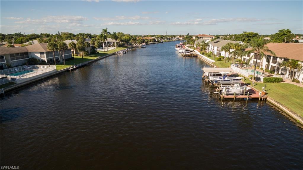 Does it get any better than a gorgeous, end unit, waterfront condo to escape to in Florida?! Updated condo on the 200ft  Rubicon canal. Enjoy pool by day and sunsets in the evening with the Western view. Features include new laminate and tile flooring, new interior paint, new kitchen, and bathrooms upgraded. The kitchen has new Stainless Appliances, granite counters, and soft close kitchen cabinets. Both bathrooms are upgraded including the tile floors, cabinets, and matching granite tops. If boating is your passion you can add a dock and lift. Deeded dock space is still available at this time and would need to be installed, and then your toy is out your back door! This condo is located near Downtown shopping, restaurants, and the Cape Coral Yacht-Club and fishing pier. Don't miss out on your piece of paradise!