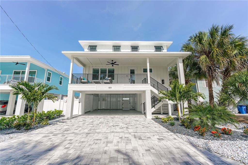 2026 New Construction, just completed and fully furnished in weekly rental area, 10 minutes walk to Downtown entertainment area.  This beautiful home is a real gem with five bedrooms and five and 1/2 baths.  Ideal as personal family retreat or vacation rental property.  There are two king bedrooms, two Queen Bedrooms and 1 bedroom with 2 sets of twin beds . Each bedroom has its own private on suite bath with four showers and one tub bath.   The home sleeps 12 people comfortably and is ideal for vacation rentals. There is a powder room on the first floor for guests.  Beautiful kitchen with stainless appliances, pantry and quartz counter tops and Island.
spacious great room and dining room with 9'4" ceiling heights to allow for tallier windows for great views.  Home is wired for  and has built in closet spaces all levels for a future elevator.

Upstairs has three bedrooms and a coffee bar for guest enjoyment.  Master bedroom is very spacious and has a large walk in closet.  All closet shelving is wood.  Laundry room with washer and dryer and built in cabinets on upper living level.
Front covered porch is 10' wide with covered stairs from below and has a great view of the Beach.
Lower level has four parking spots.  Paver drive and covered parking with a coastal epoxy finish on the concrete parking slab.
Privacy walls surround  the garage are and an exit gate to the large pool area.  Plenty of room here for lounge chairs and outdoor furnishings.  Pool equipment is elevated to avoid flooding.  there is an outdoor shower for your convenience.
Yard cover is custom stone with a combination of white and grey stone to enhance the luscious landscaping.

This property has all the upscale amenities, location and quality of construction  to make it a fantastic investment.