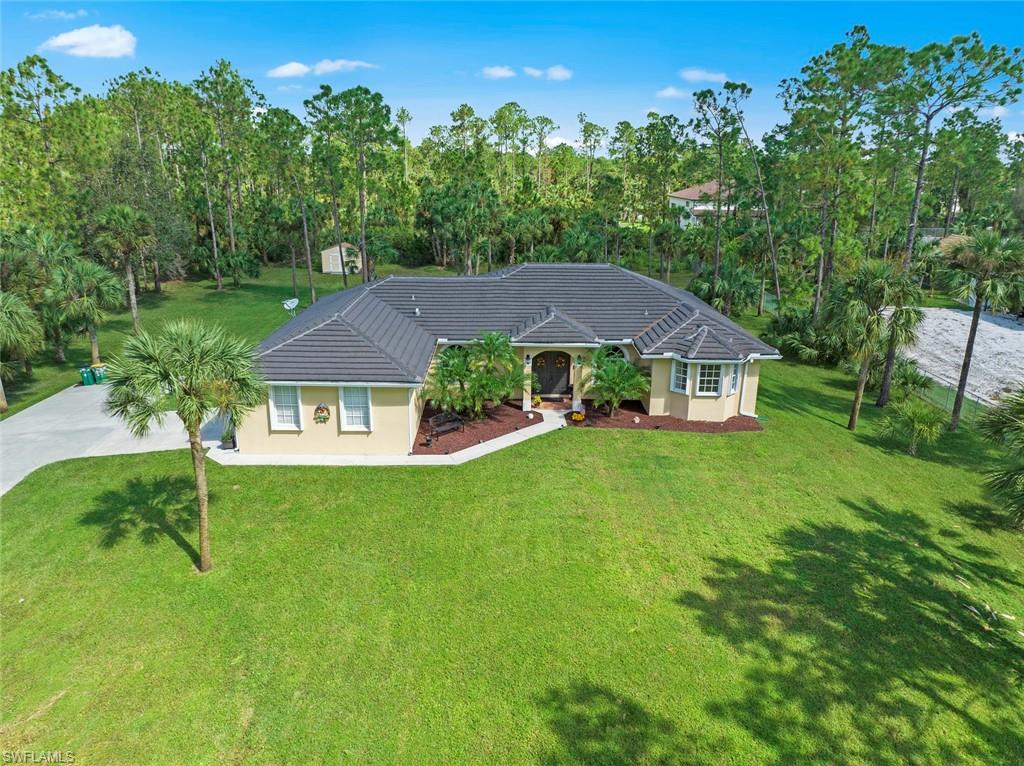 Welcome home to Estate living at its finest! Drive through quiet country streets and down the inviting, tree-lined driveway to the gorgeous double-door entry. Available fully furnished, the interior of this impeccably maintained home features a split floorplan, formal living and dining rooms, and an open-concept kitchen, breakfast nook, and family room, all looking out onto the screened lanai and stunning backyard. Impact windows in the front mean that even when the shutters are up you'll never be without a view, and an almost new AC, roof, and gutters give you ultimate peace of mind. Come make this amazing house your home!